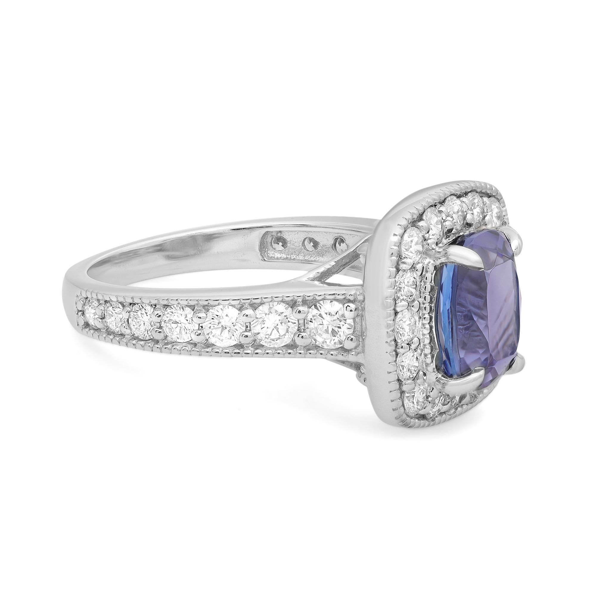 This gorgeous engagement ring mounted in 14k white gold is a perfect addition to a statement look. The center Cushion cut Tanzanite weighing 2.00 carats is illuminated by a sparkling halo of round brilliant cut diamonds totaling 0.48ct. To complete