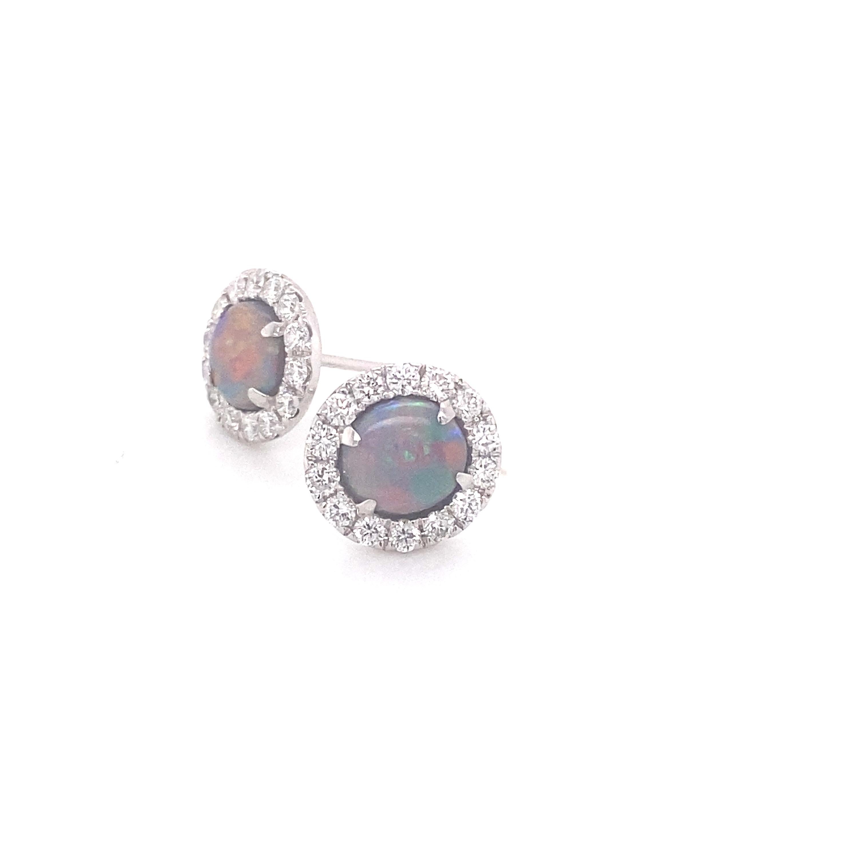 These beautiful stud earrings feature 2.00ctw of natural oval opals surrounded by a halo of .86ctw diamonds. These are set in 18 karat white gold and have a friction post back. Each opal is sourced from the Lightning Ridge area of Australia and is