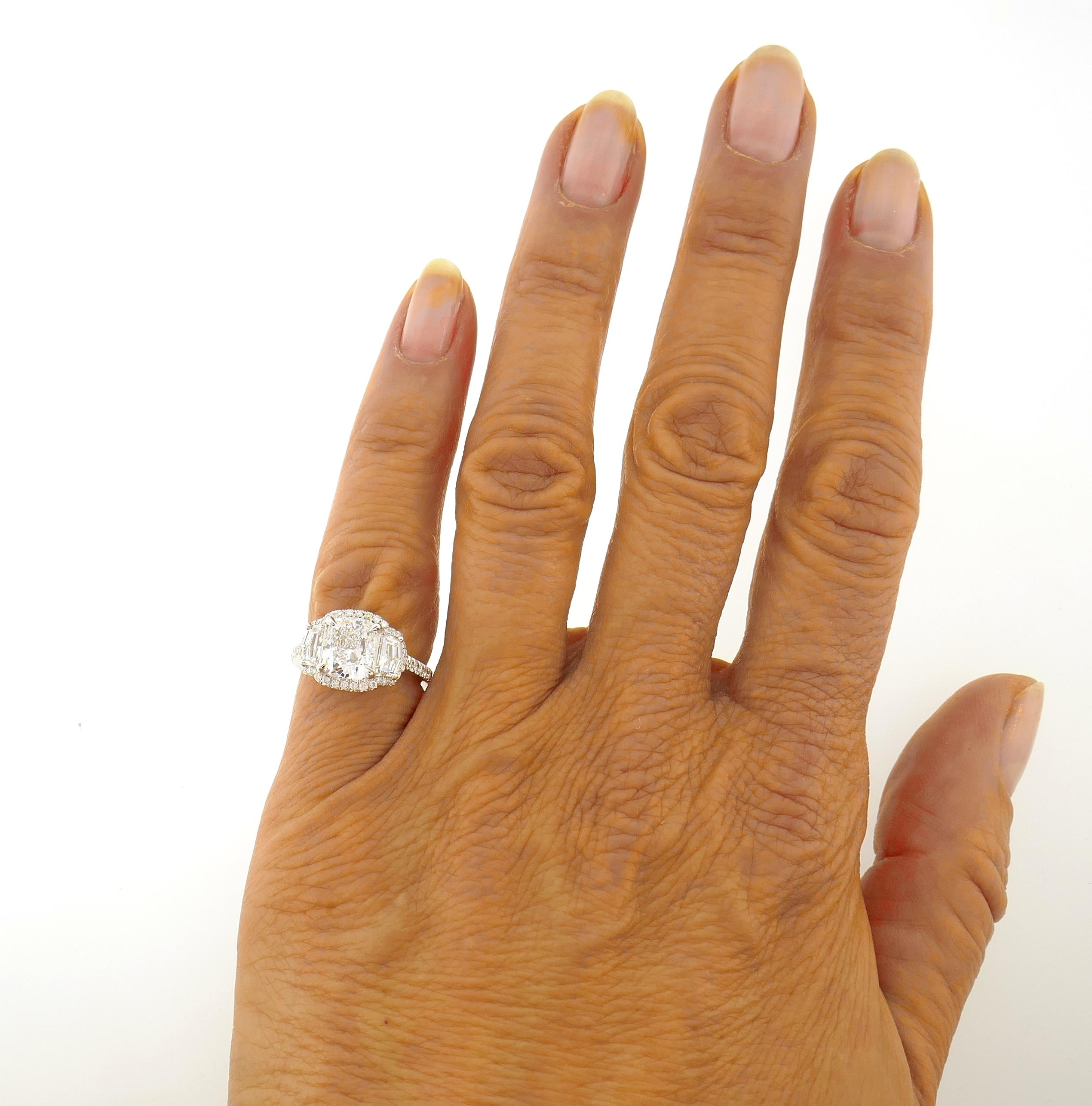 Superb quality diamond ring! Features an as white as it can get cushion cut diamond flanked with two rare 