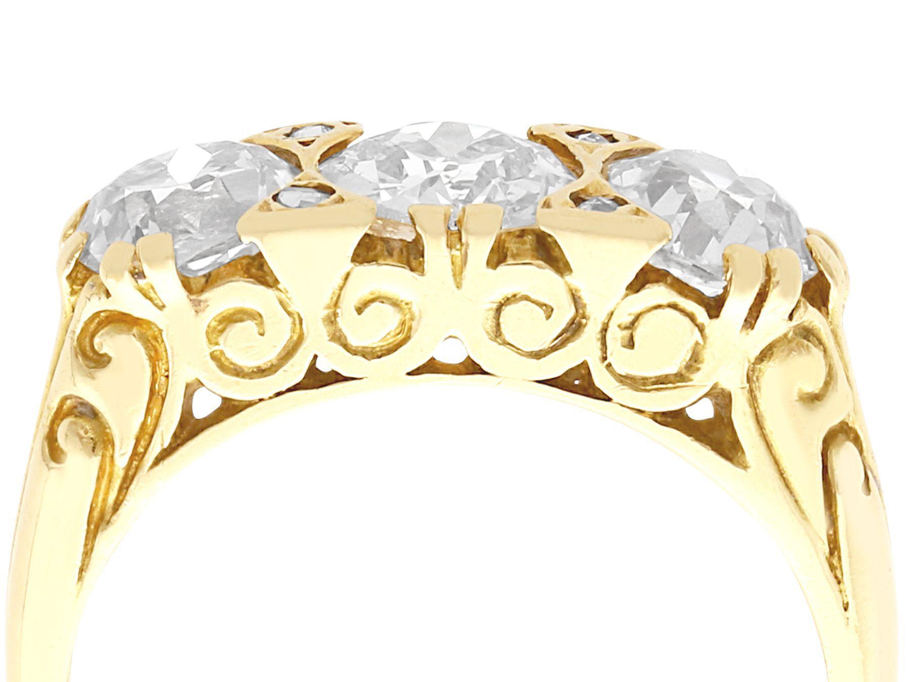 A stunning, fine and impressive antique and contemporary 2.01 carat diamond, 18 karat yellow gold, three stone ring; part of our antique jewelry and estate jewelry collections

This stunning, fine and impressive antique and contemporary trilogy ring