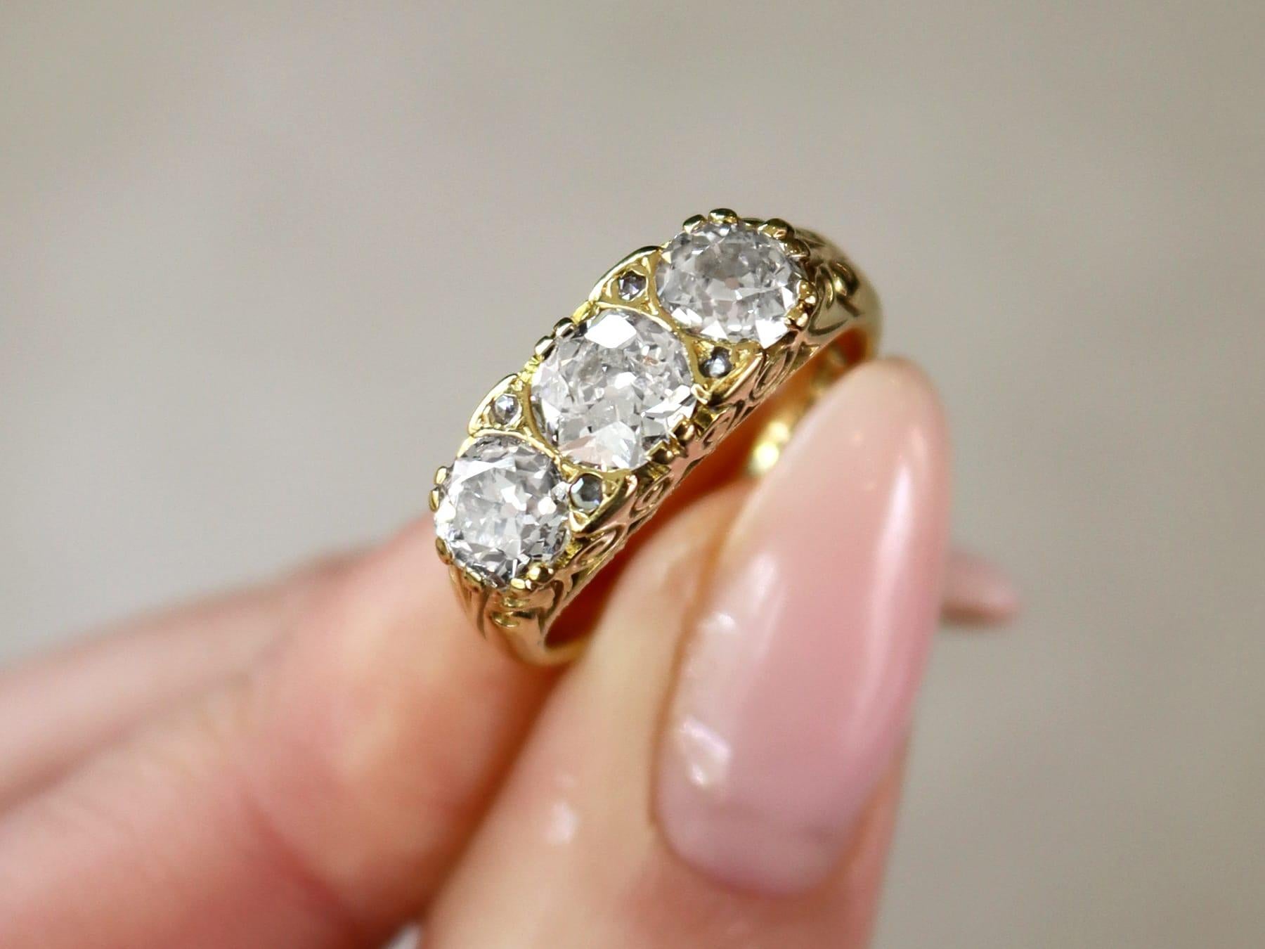 A stunning, fine and impressive antique and contemporary 2.01 carat diamond, 18 karat yellow gold, three stone ring; part of our antique jewelry and estate jewelry collections.

This stunning, fine and impressive antique and contemporary trilogy
