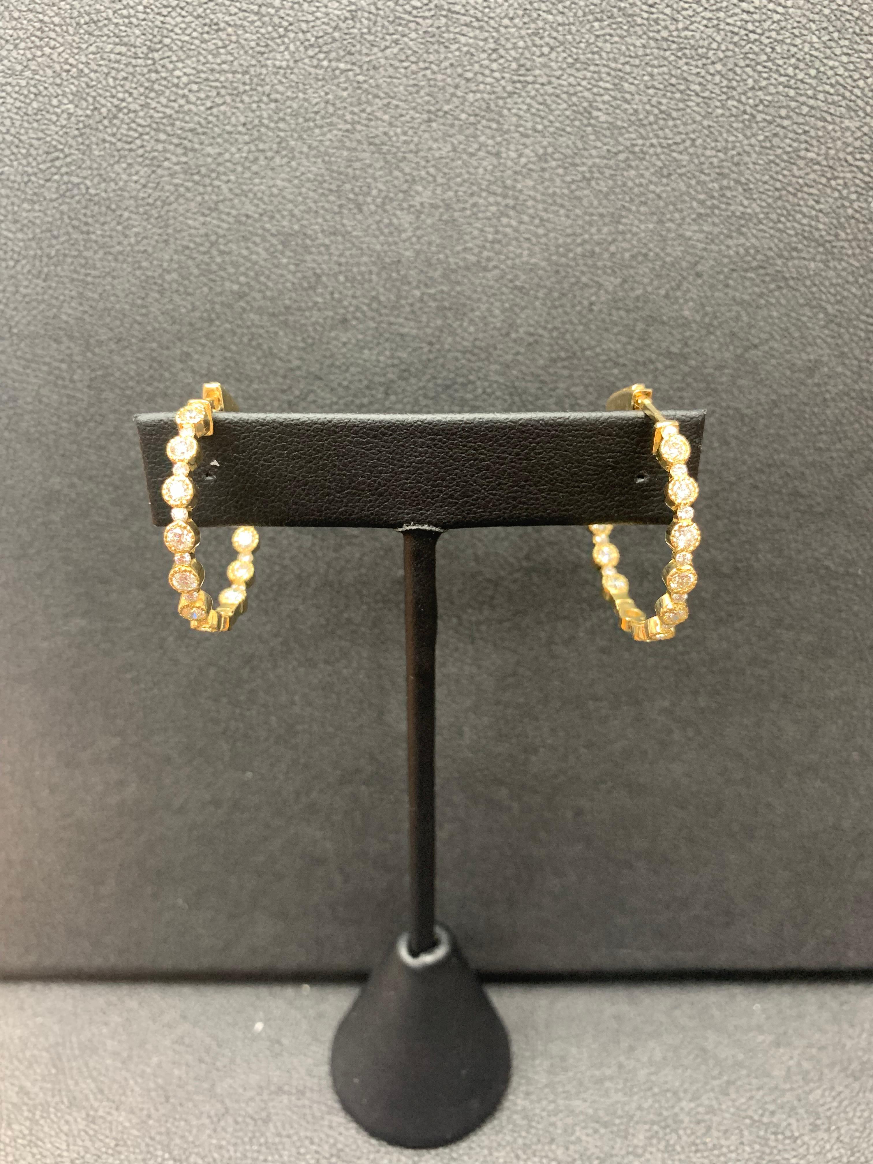 Gorgeous and classic diamond hoop earrings. Features dazzling round diamonds set in 14k Yellow Gold to maximize the brilliance of the diamonds. Total weight of the diamonds is 2.01 carats.

All diamonds are GH color SI1 Clarity.
Available in Yellow