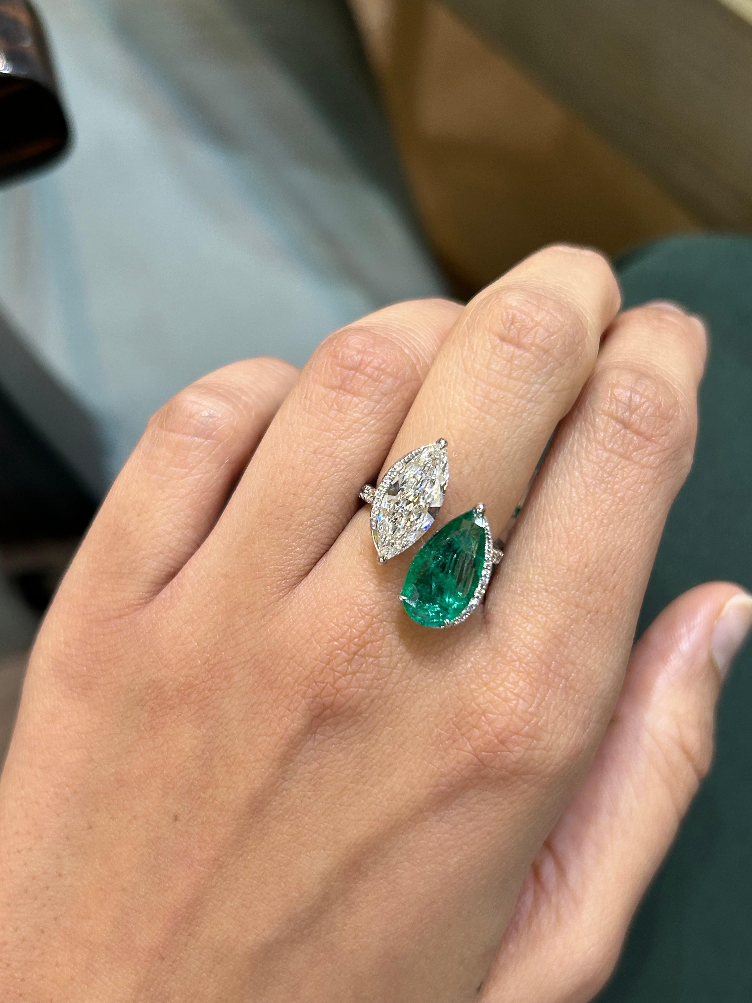 One of a kind, certified 2.01 carat H color SI1 clarity marquise shaped Diamond with 2.58 carat Zambian Emerald, and 0.32 carat round diamonds. All set in solid 18K White Gold. Currently sized at US7, can be resized. 