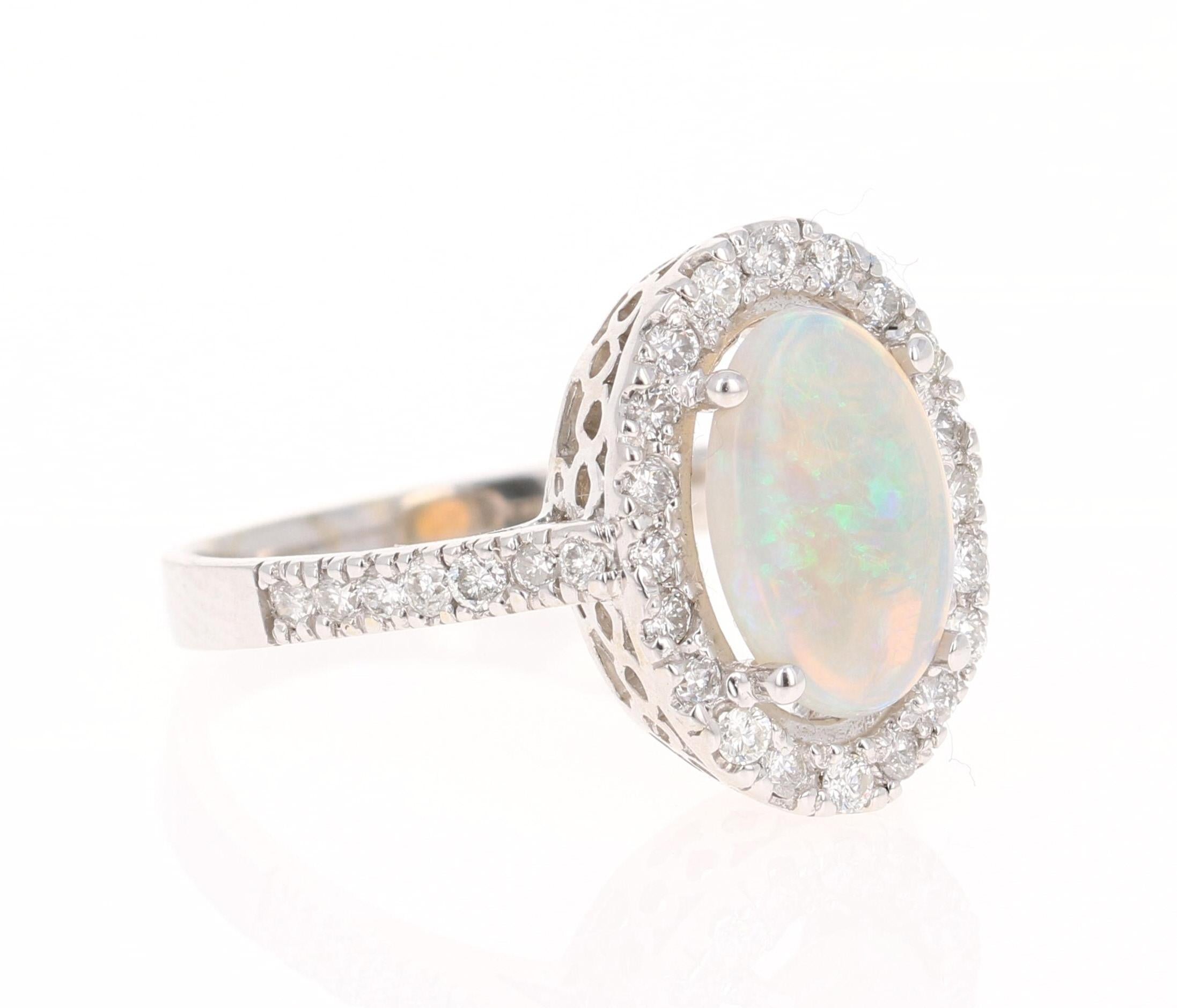 This ring has a cute and simple 1.49 Carat Opal and has 34 Round Cut Diamonds that weigh 0.52 Carats. (Clarity: VS, Color: H) The total carat weight of the ring is 2.01 Carats. 

The Opal measures at 11 mm x 7 mm and the face of the ring is 17 mm x