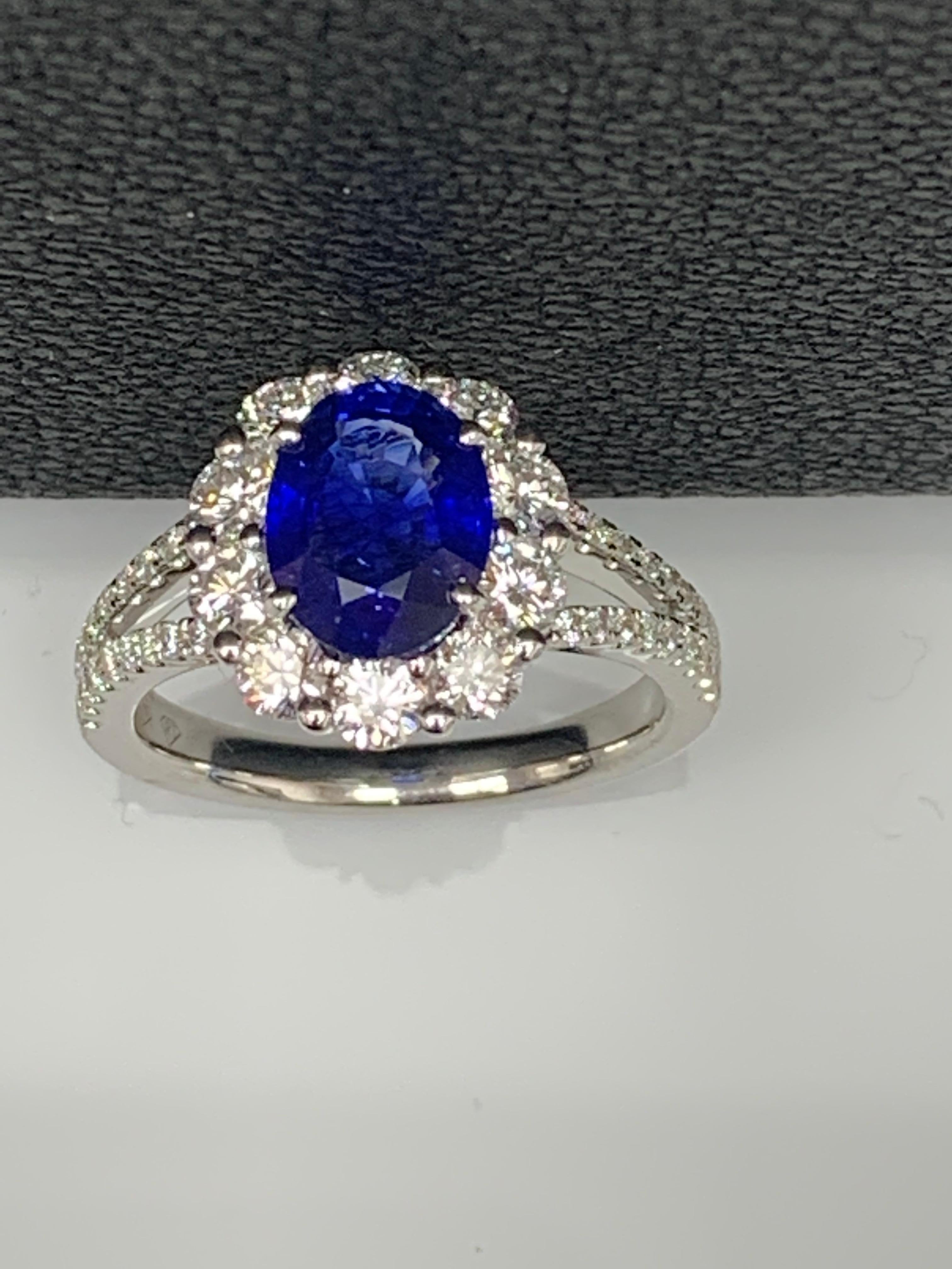 Features a beautiful 2.01-carat oval shape blue sapphire at the center. Surrounded by 10 brilliant-cut round diamonds weighing 0.87 carats in total. Diamonds are also set halfway all over the shank of the ring. The weight of the 36 accent diamonds