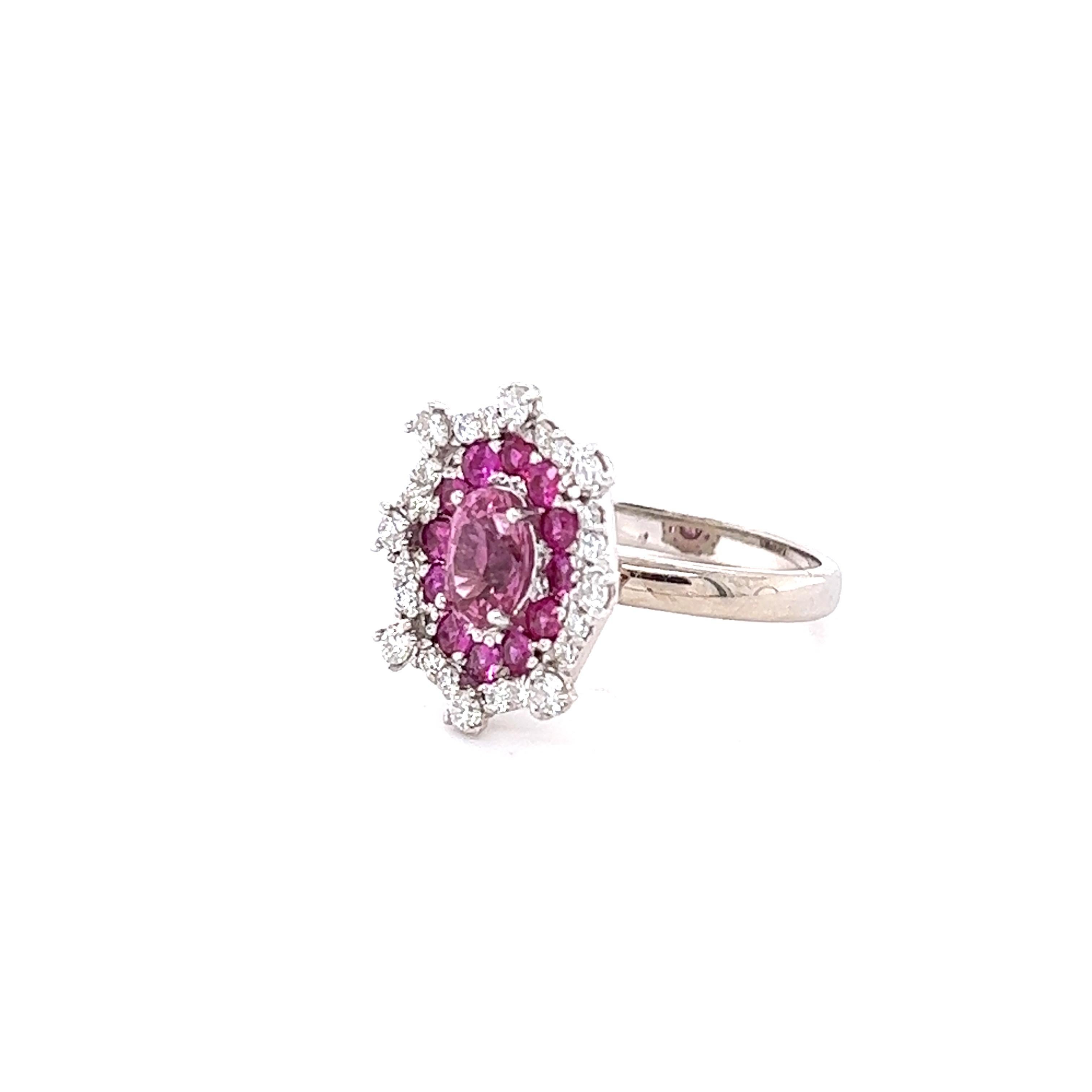 This ring has a Oval Cut Pink Sapphire that weighs 1.02 carats. The measurements of the Sapphire are approximately 7 mm x 5 mm. It also has 12 Round Cut Pink Sapphires that weigh 0.58 carats. There 24 Round Cut Diamonds on the shanks of the ring
