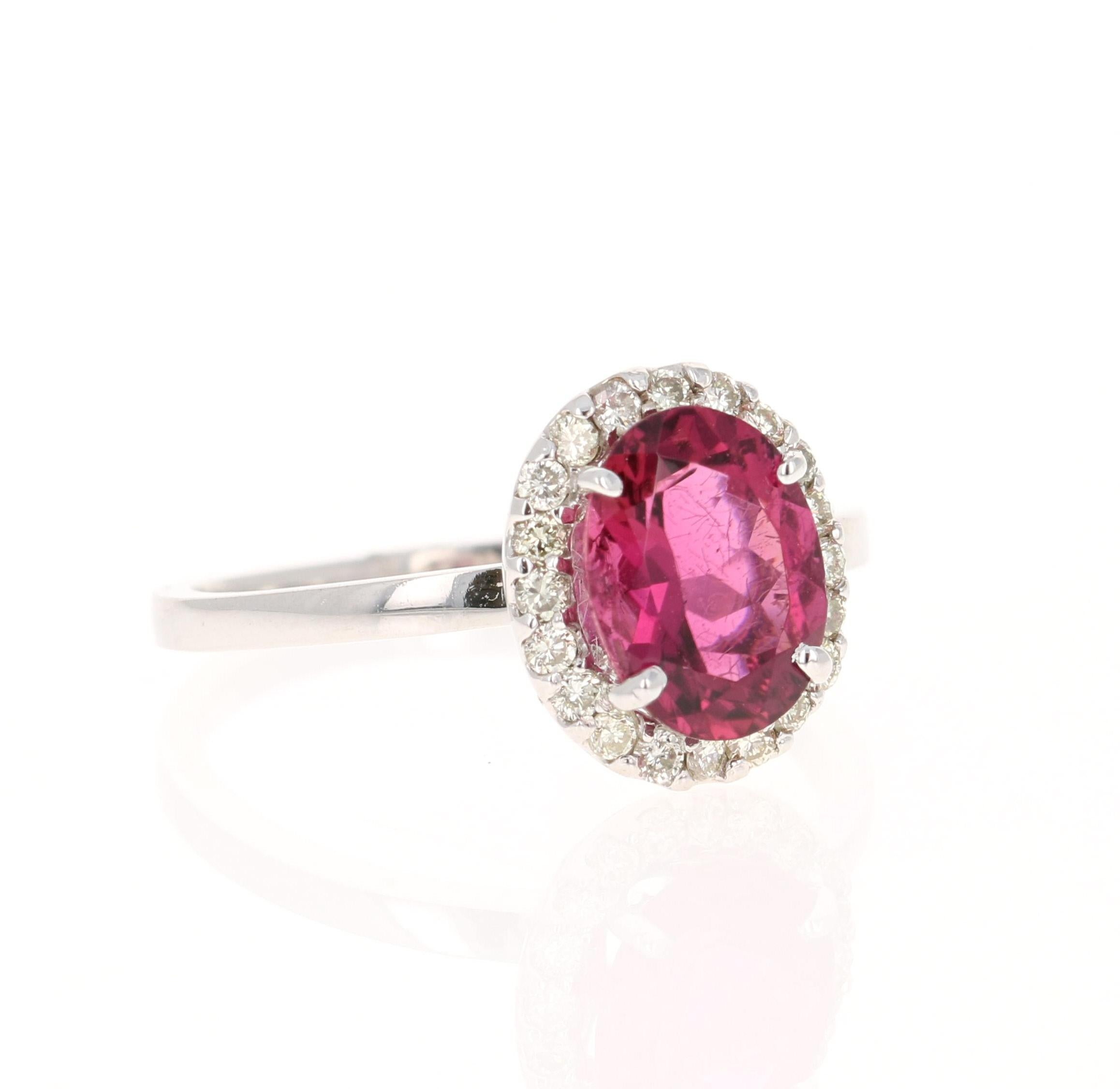 This ring has an Oval Cut Hot Pink Tourmaline that weighs 1.76 Carats. Surrounding the tourmaline are 20 Round Cut Diamonds weighing 0.25 Carats. 
The total carat weight of the ring is 2.01 Carats. 

The tourmaline measures at 9 mm x 7.5 mm (length