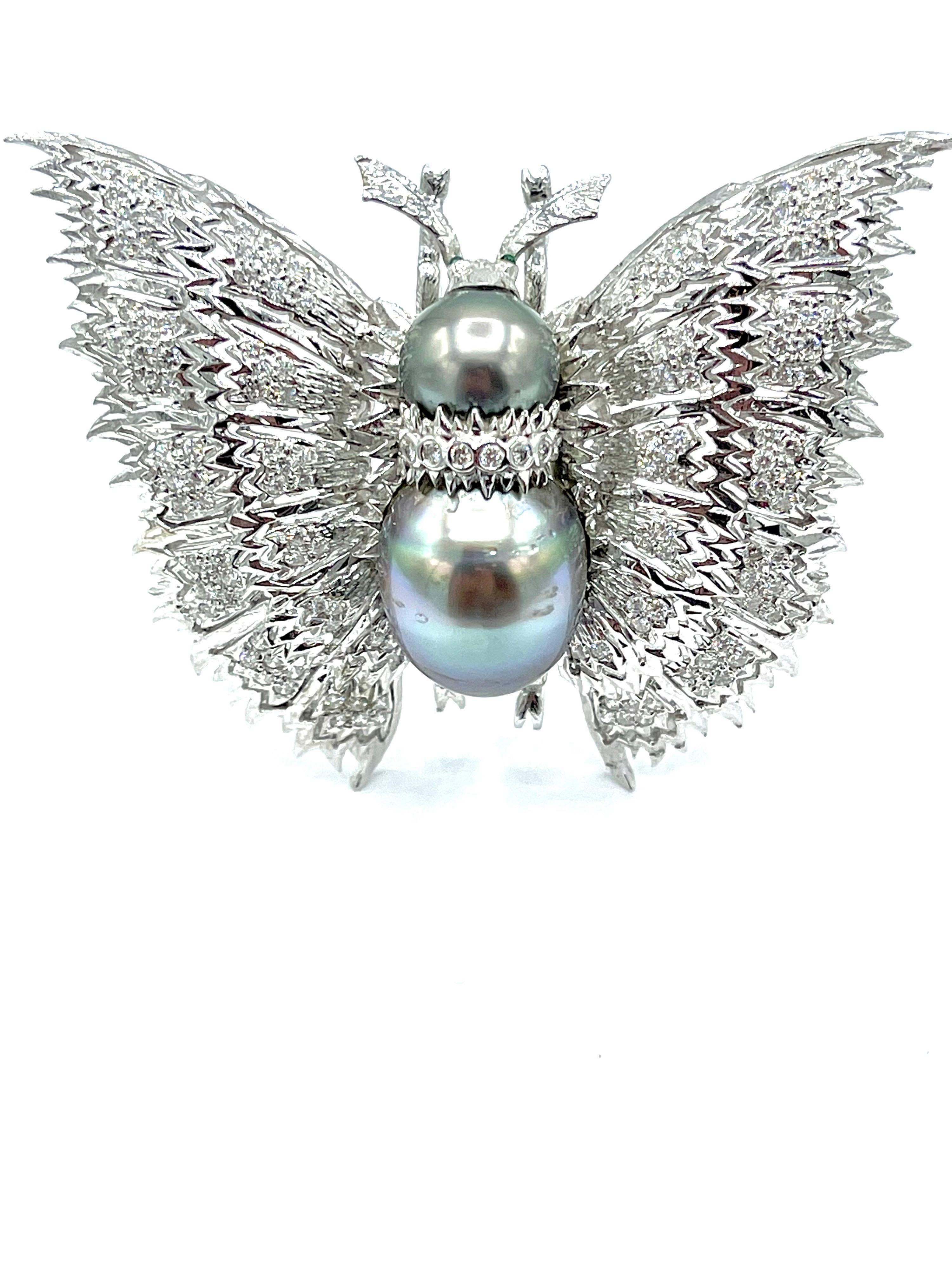A wonderfully handcrafted butterfly brooch!  The butterfly wings are set with round brilliant Diamonds in 18K white gold, weighing 2.01 carats total, and the body consists of two Tahitian Pearls of 11.20mm and 18.00mm.  The back side of the