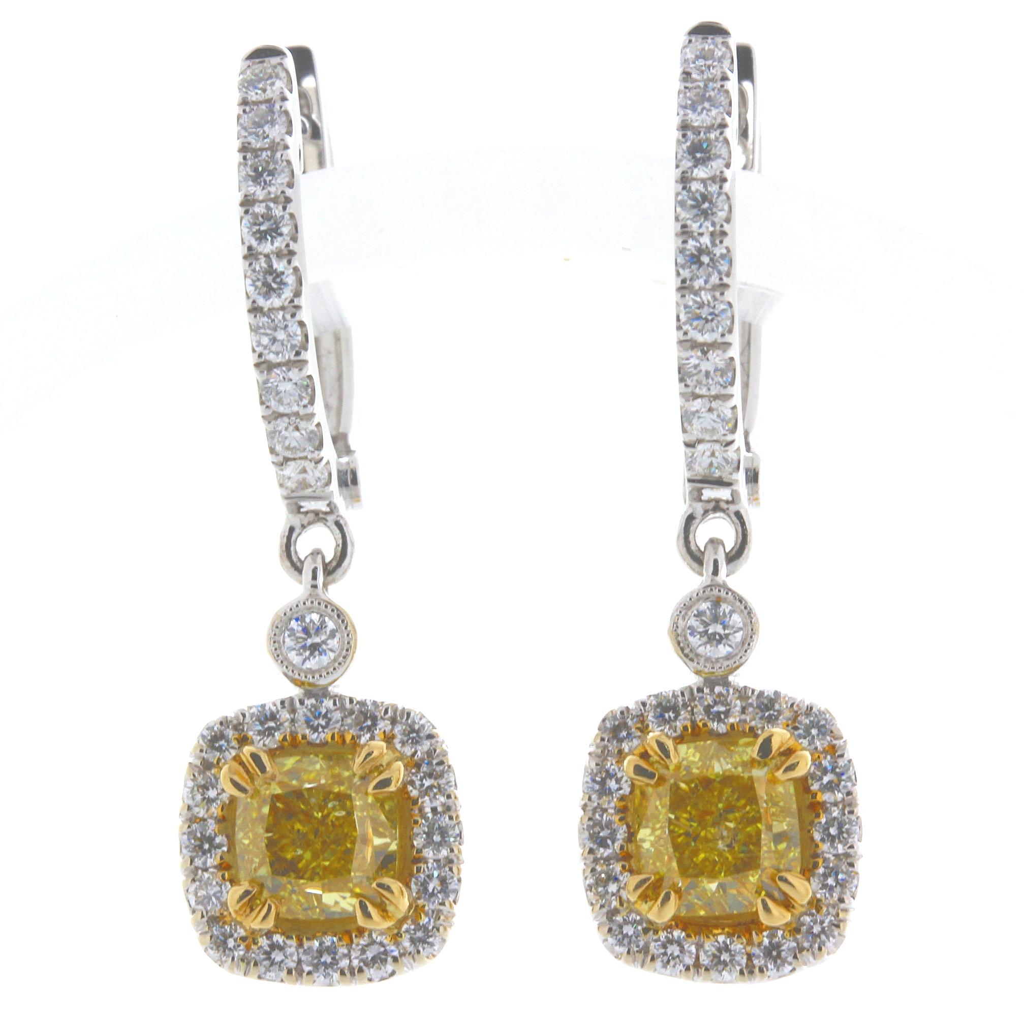 Video available upon request. 
Perfectly matched Pair of 2.01 Carat Total Weight Cushion Cut, Natural Vivid Yellow Color, Even SI2 Clarity, 18 Karat Yellow and White Gold Diamond Earrings.
One Diamond weights 1.00 Carat and the other Diamond weights