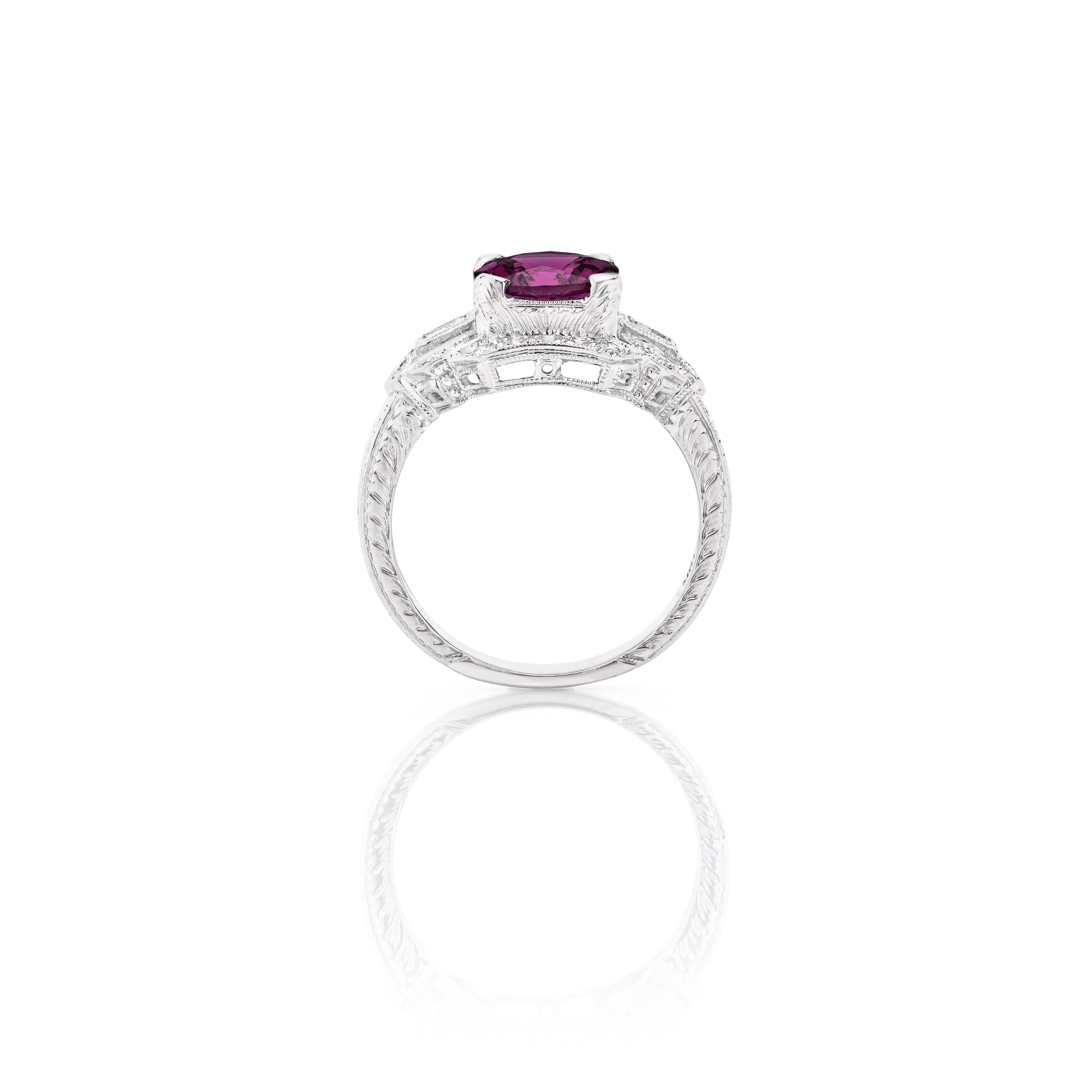 A wonderful low profile ring.  Beautiful from every angle.

Ring Details:

Round Brilliant Rhodolite Garnet weighing 1.77 Carats
(20) Round Brilliant and (2) Baguette Cut Diamonds weighing approximately 0.24 Carats

Total Gem Weight:  2.01