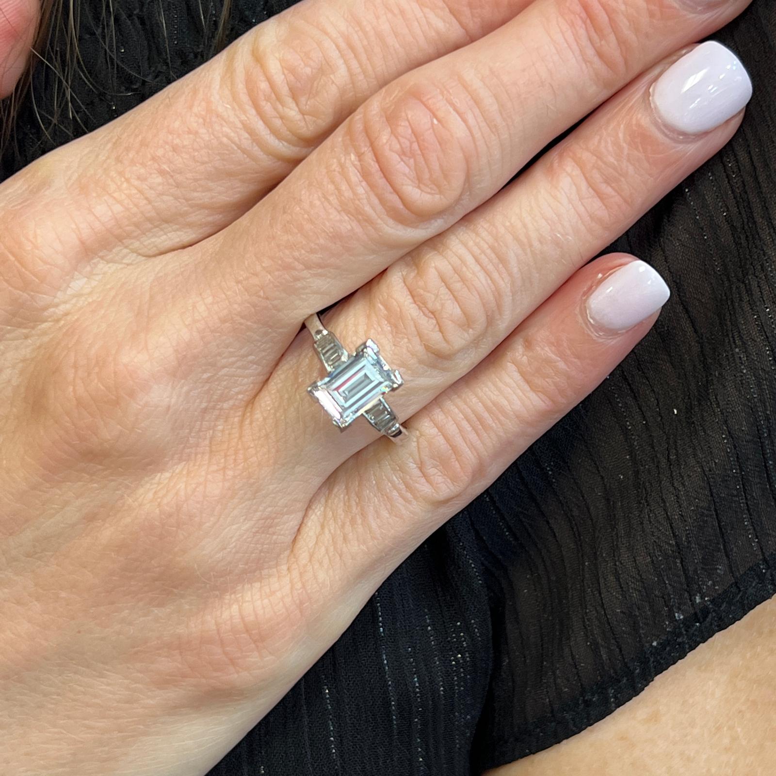 Elongated diamond vintage engagement ring handcrafted in platinum. The elongated rectangular step cut diamond is circa 1940's, and is diamond is graded F color and SI1 clarity by the GIA (see the report in photos). The mounting features 6 straight