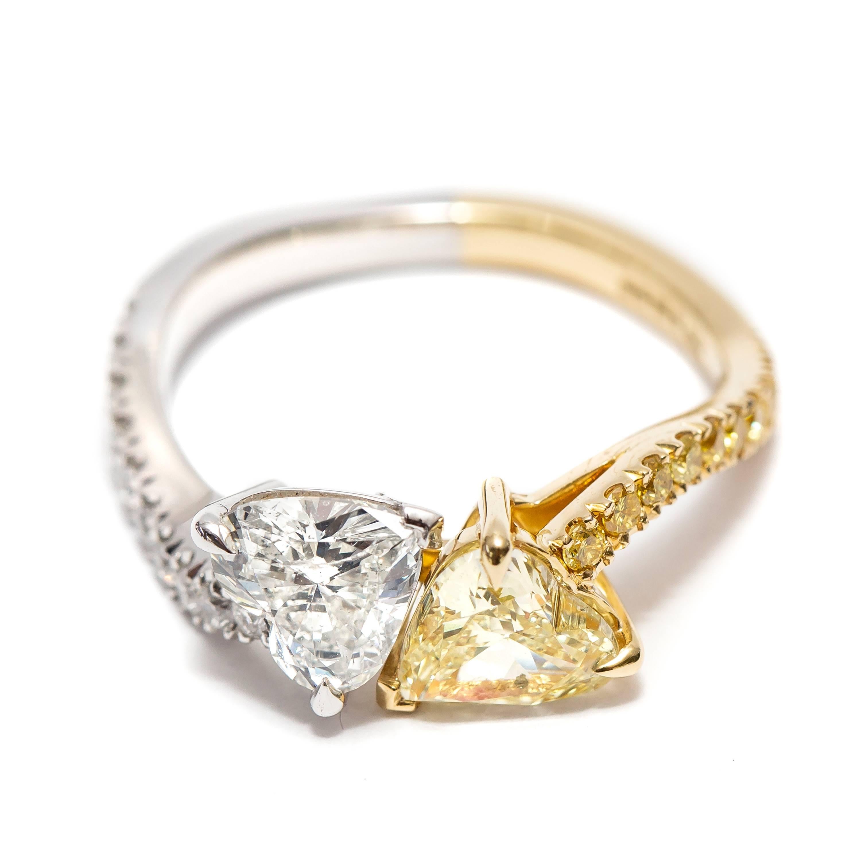 This Stunning 1.70 Carat total double Heart Shape White and Yellow Diamond Engagement Ring Clarity SI2 features 0.16 Carat of White Round Brilliant Diamonds in Platinum and 0.15 Carat of Fancy Intense Yellow Diamonds set in 18 Karat Yellow Gold,