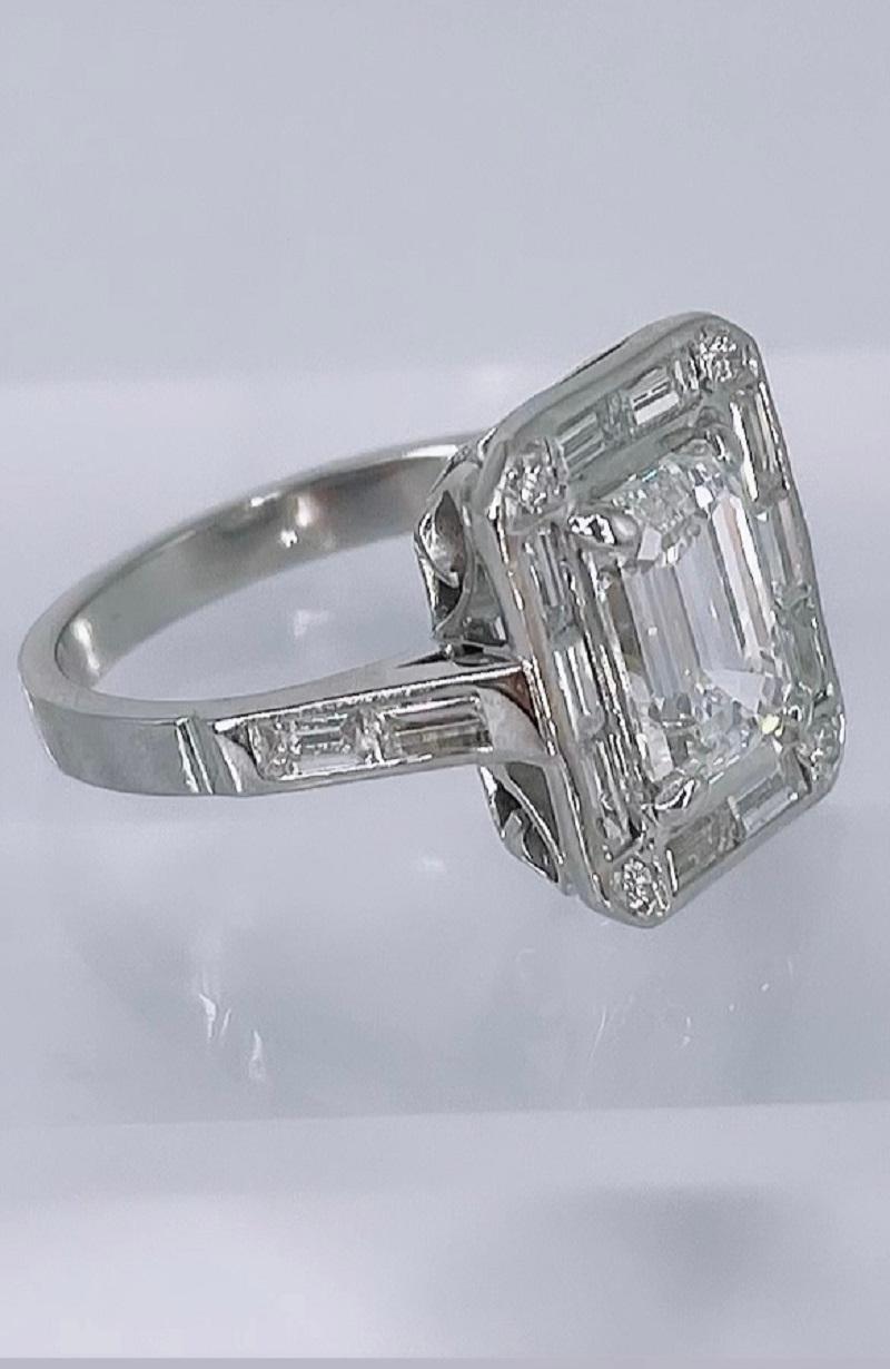 This exquisite piece by J. Birnbach is inspired by the detailed craftsmanship of the Art Deco period. This elegant engagement ring features a 2.01 carat emerald cut diamond, GIA certified as G color and SI2 clarity. This diamond is an exceptional