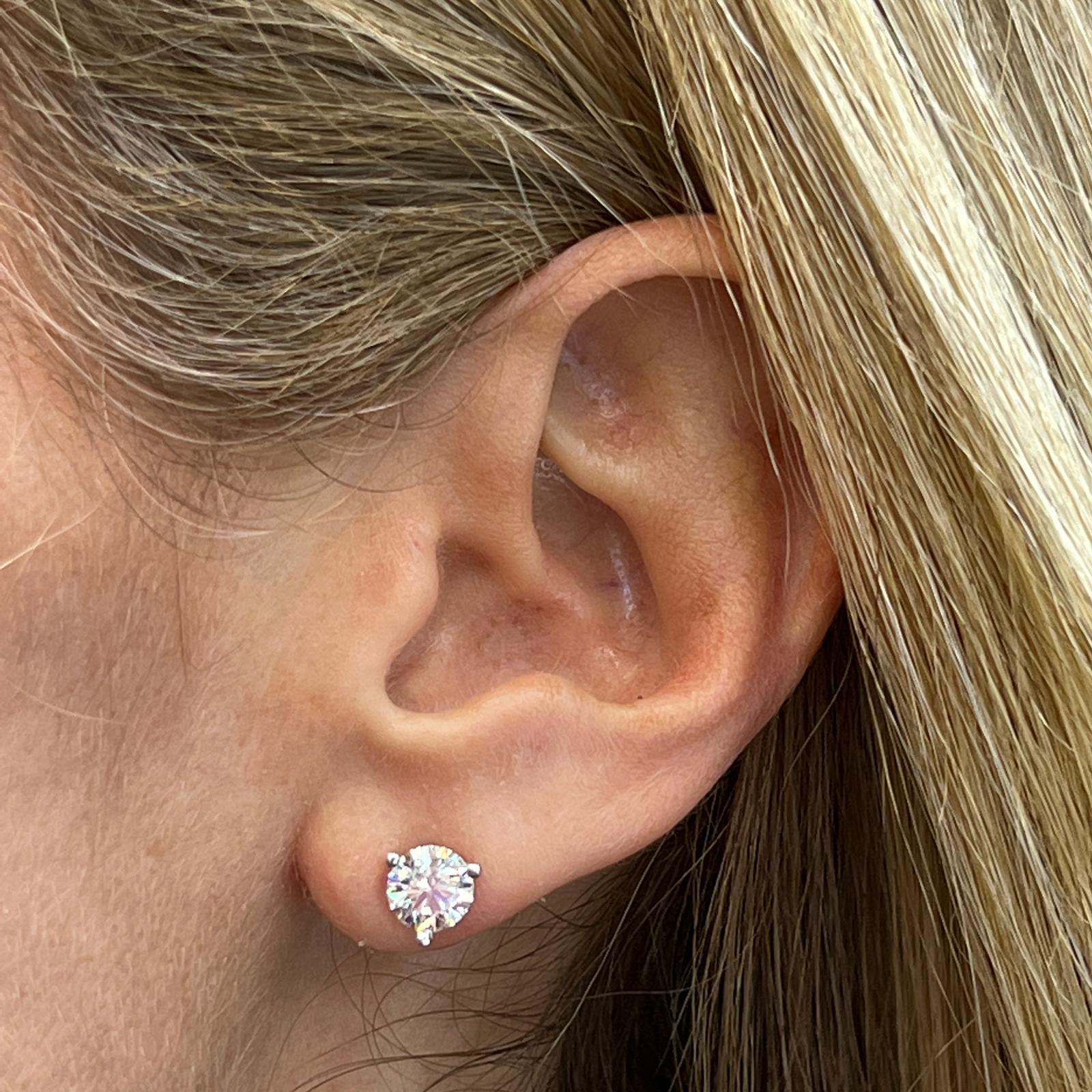 2.01 Carat total weight diamond stud earrings set in 3 prong martini 14 karat white gold mountings. The round brilliant diamonds are GIA certified E color, SI1 clarity, and triple excellent cut, polish, and symmetry. 