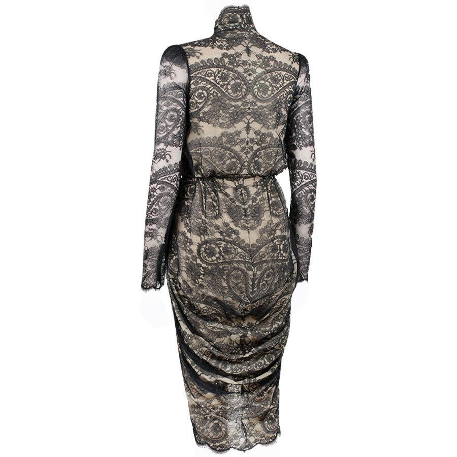 2010 Alexander McQueen Black Lace Dress

Fully lined in a nude silk chiffon and wraps to close with hidden snaps.
Cuffs are zippered.
IT Size 38
Excellent condition
New