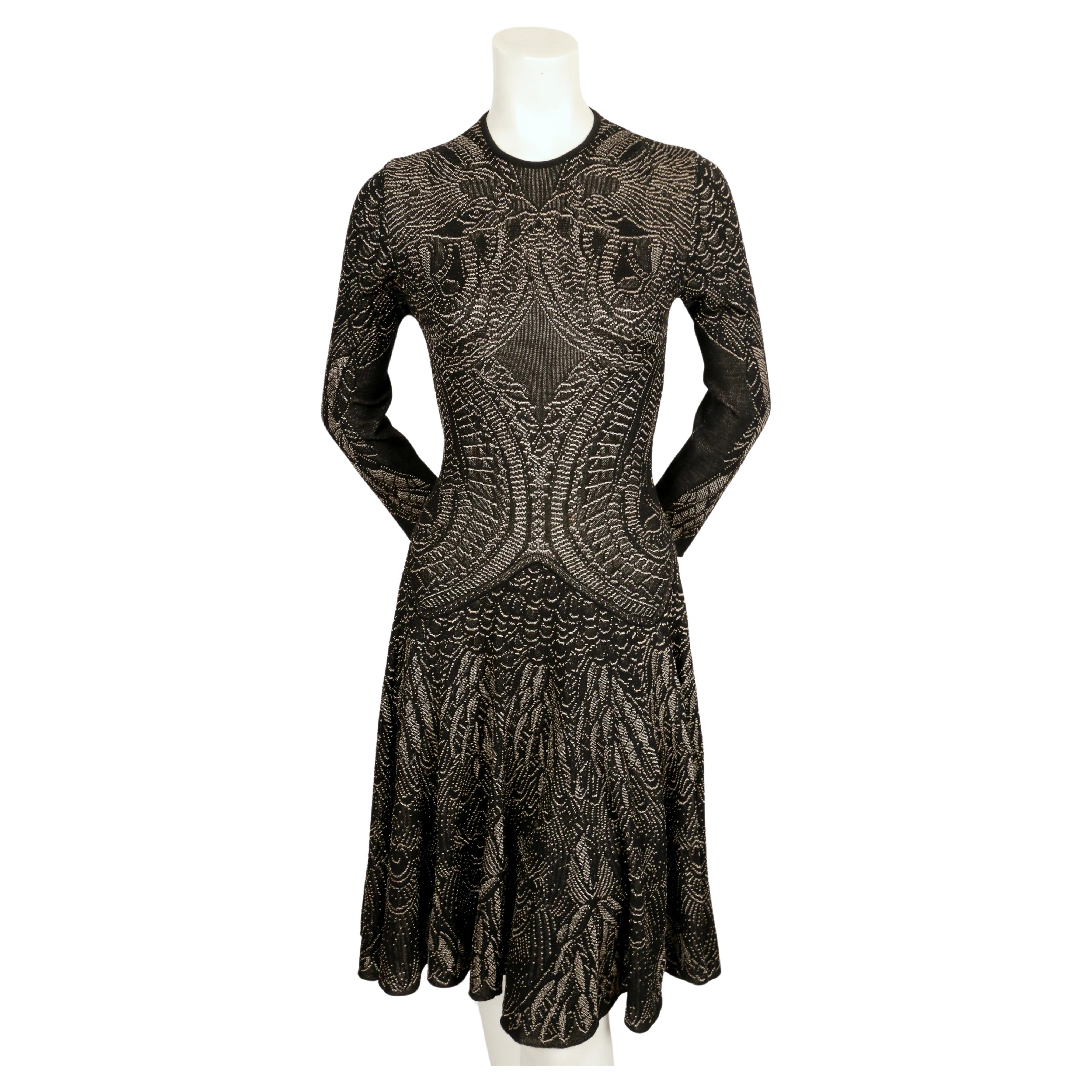 Very rare intarsia knit dress with wing motif and three-quarter sleeves created by Alexander McQueen dating to fall of 2010. No size indicated although this best fits a S or M. Approximate measurements (unstretched):  shoulder 14.5