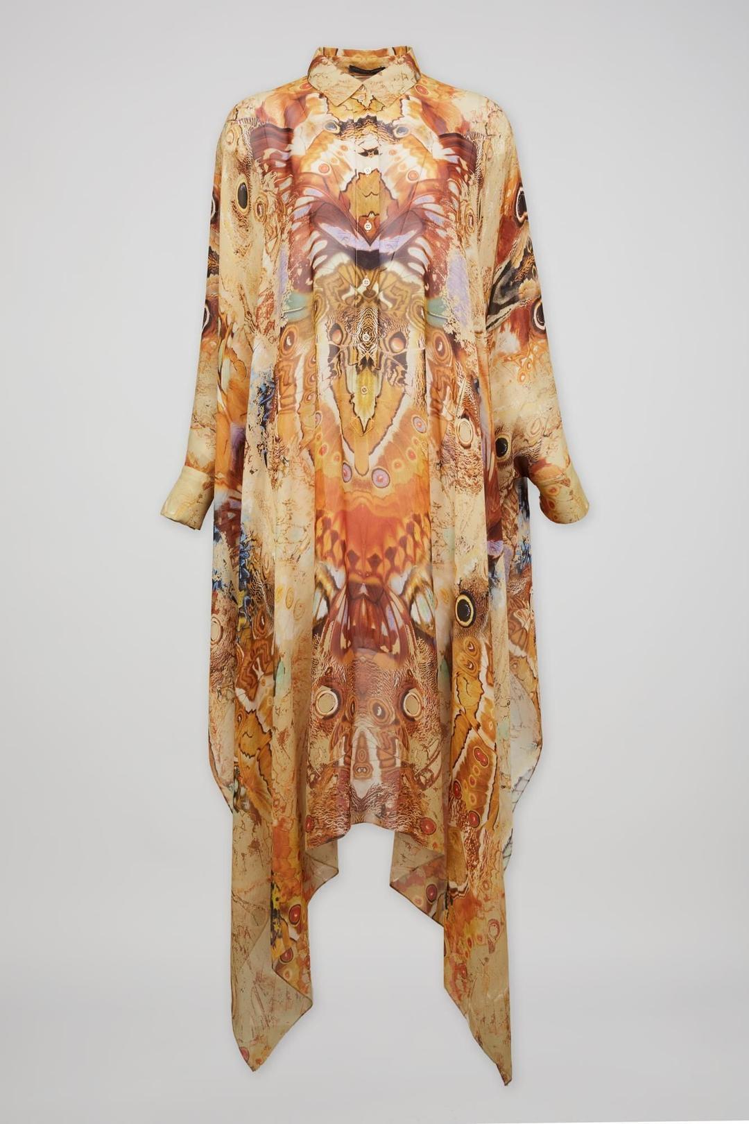 The dress is a mid-length, 100% silk caftan style by Alexander McQueen. Sheer and unlined with now iconic 