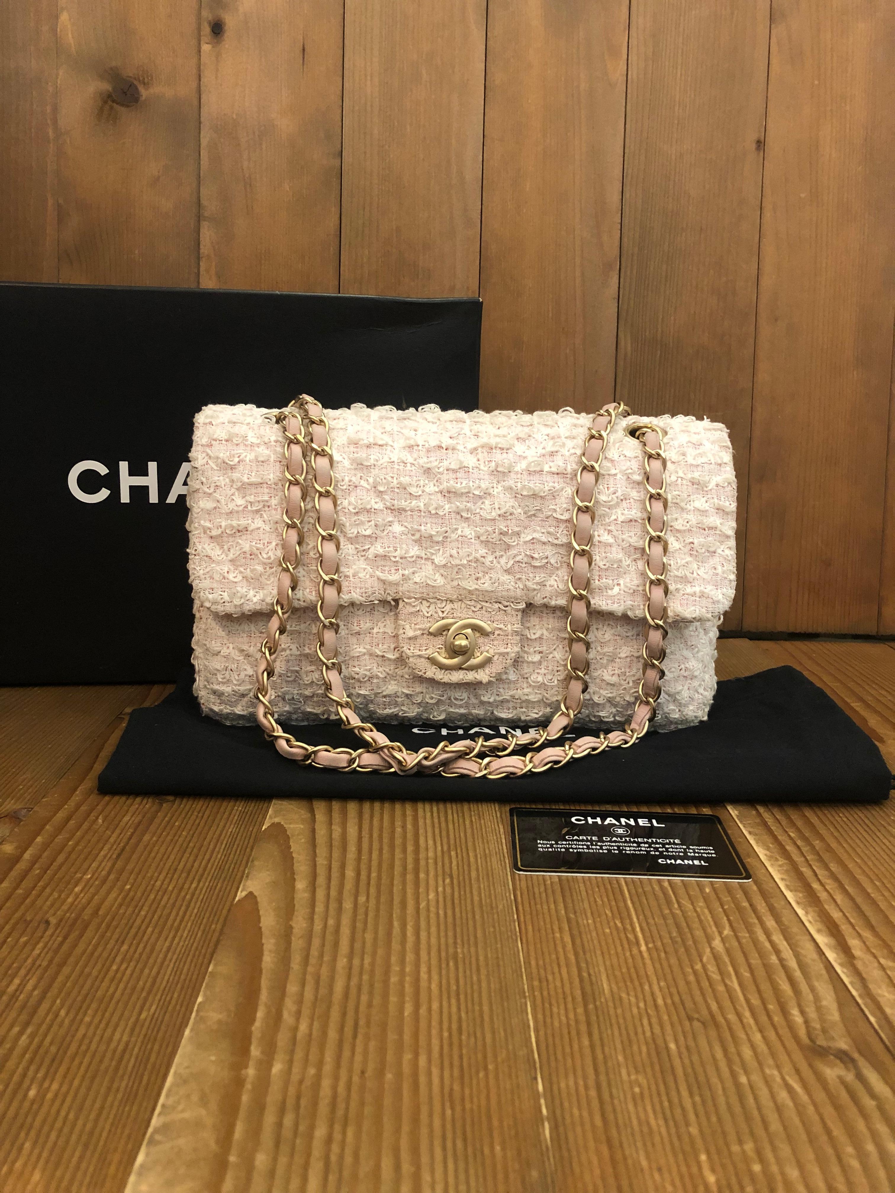 This CHANEL classic single flap bag is crafted of quilted tweed fabric in baby pink and brushed gold-toned hardware. Front flap with CC turn-lock closure lined with pink lambskin leather opens to a pink fabric interior with one zippered and patch