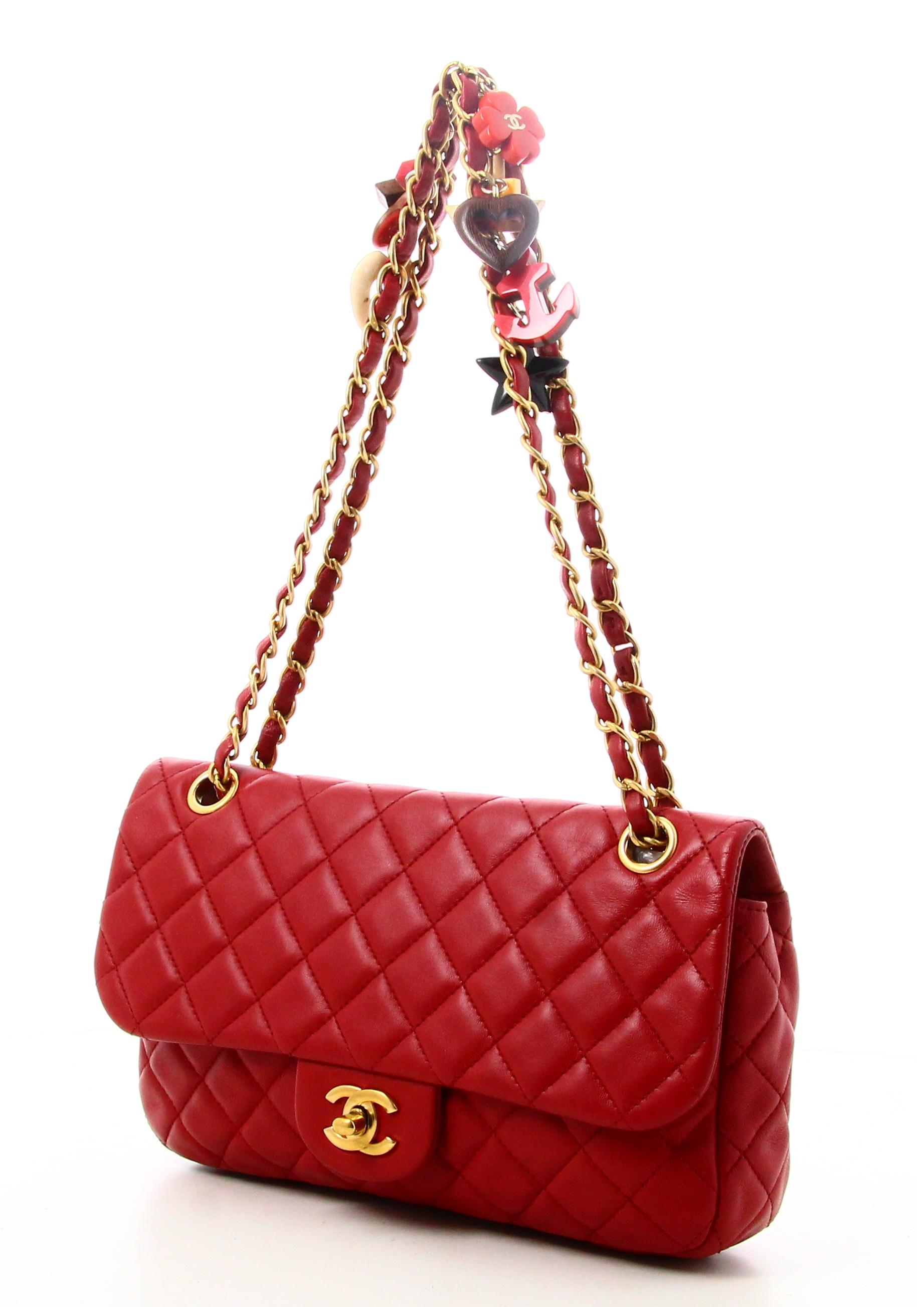2010 Chanel Timeless Handbag Red Quilted Leather

- Very good condition. Shows slight signs of wear over time. 
- Chanel handbag 
- Red quilted leather
- Double Chain with different objects and shapes on the chains 
- interior: beige fabric plus