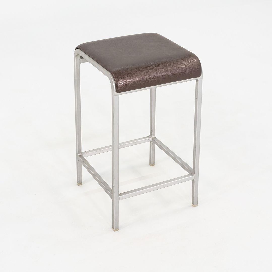 This is a 20-06 Stool, originally designed by Norman Foster for Emeco in 2006. These particular examples were produced in the United states in 2010. They feature Emeco's signature recycled aluminum frame paired with brown leather upholstered