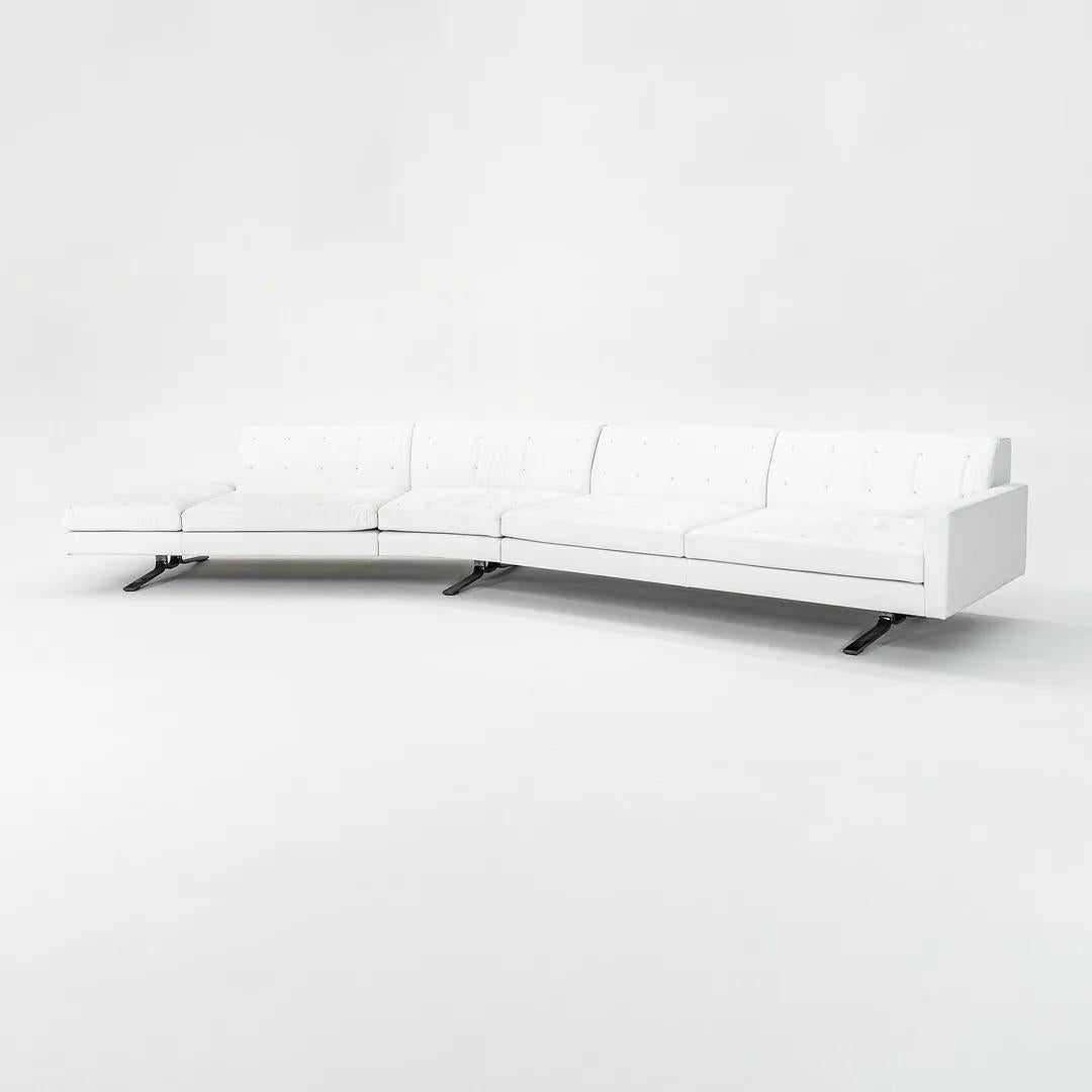 This is a ‘Kennedee’ sofa, initially designed by Jean-Marie Massaud for Poltrona Frau in 2006. This particular sofa was manufactured in Italy in 2010. The piece features a hand-stitched white leather upholstery and has a drawn steel base in a