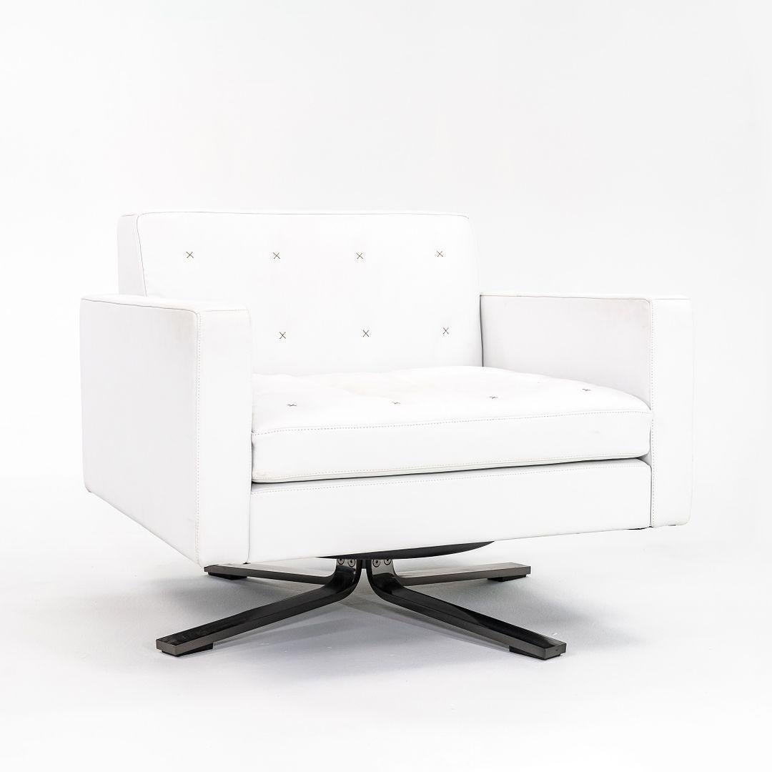 This is a Kennedee swivel lounge chair, initially designed by Jean-Marie Massaud for Poltrona Frau in 2006. This particular chair was manufactured in Italy in 2010. This model features a hand-stitched, white leather upholstery, and has a 4-star