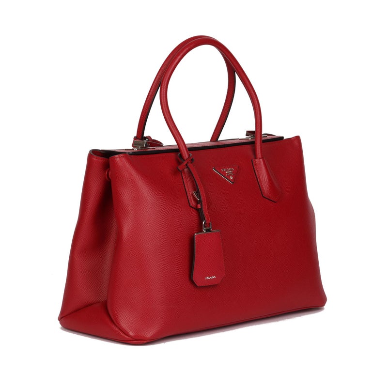 PRADA
Red Saffiano Leather Twin Tote

Xupes Reference: CB472
Serial Number: 56
Age (Circa): 2010
Accompanied By: Prada Dust Bag, Clochette Luggage Tags, Authenticity Card, Care Booklet, Handle Keeper
Authenticity Details: Date Stamp (Made in