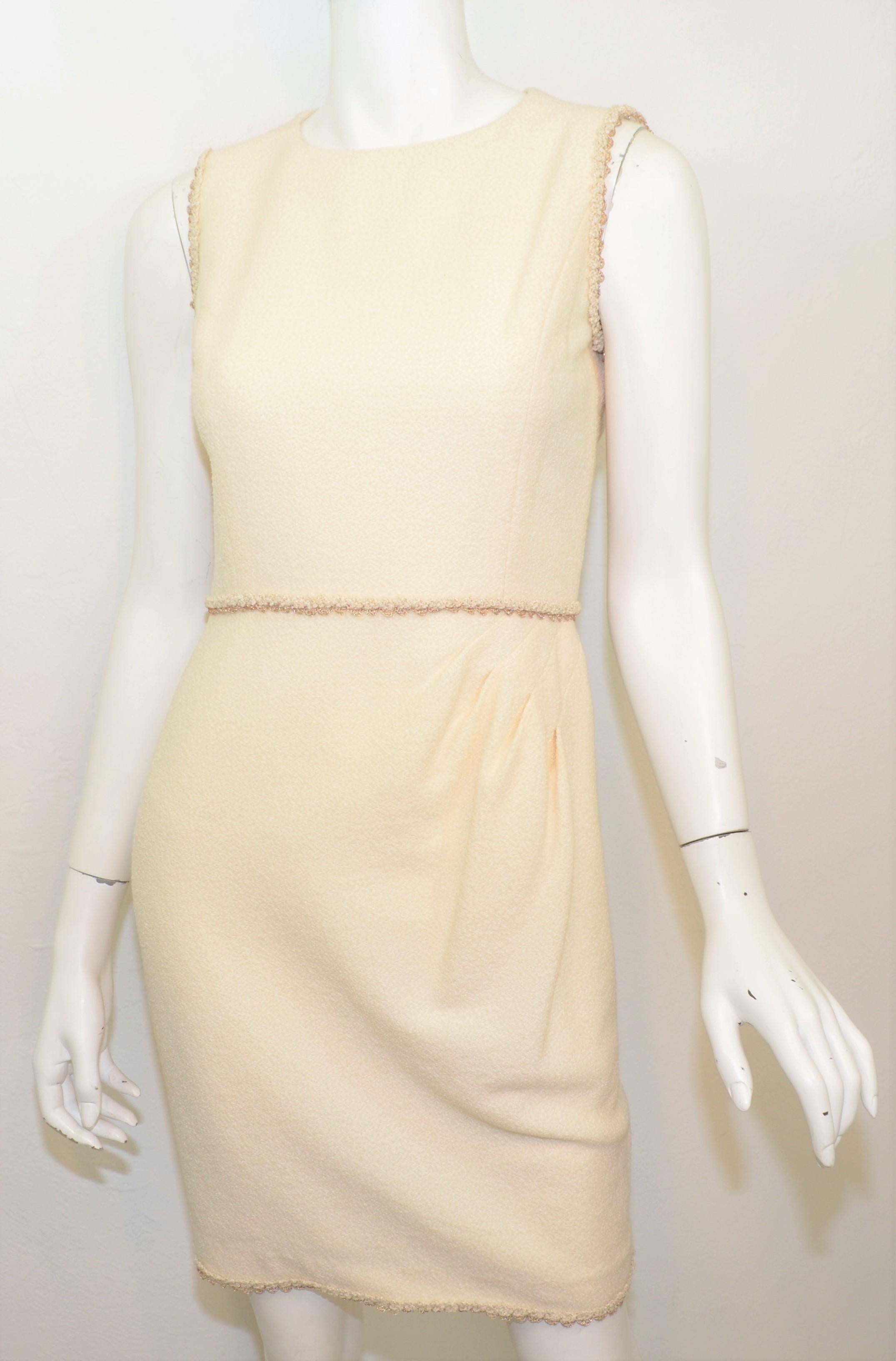2010 Resort Collection Chanel Cream Knit Dress NWT -- Dress is featured in a cream/ivory color composed with a wool blend knit fabric with bronze threading along the waistline, hem, and trims of the sleeves. Subtle ruching on the left side of the
