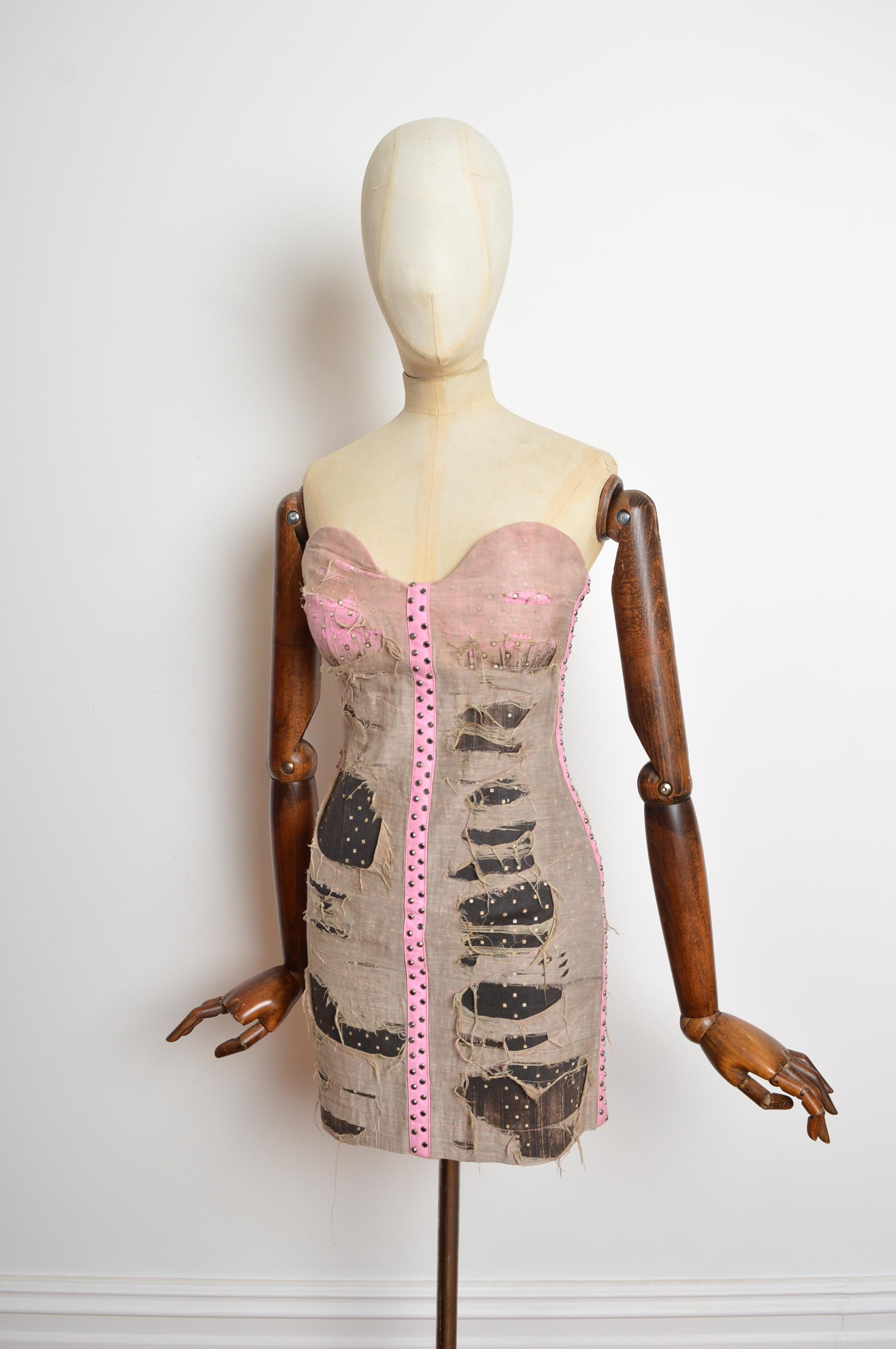 2010 Roberto Cavalli Bustier dress in a distressed gauze finish with studded details, exposed zip up back and accents of pink denim. Unworn and new with tags. 
Size; Recommended size UK 6
Measurements are provided in inches (‘’)
Pit to Pit; 15”
Top