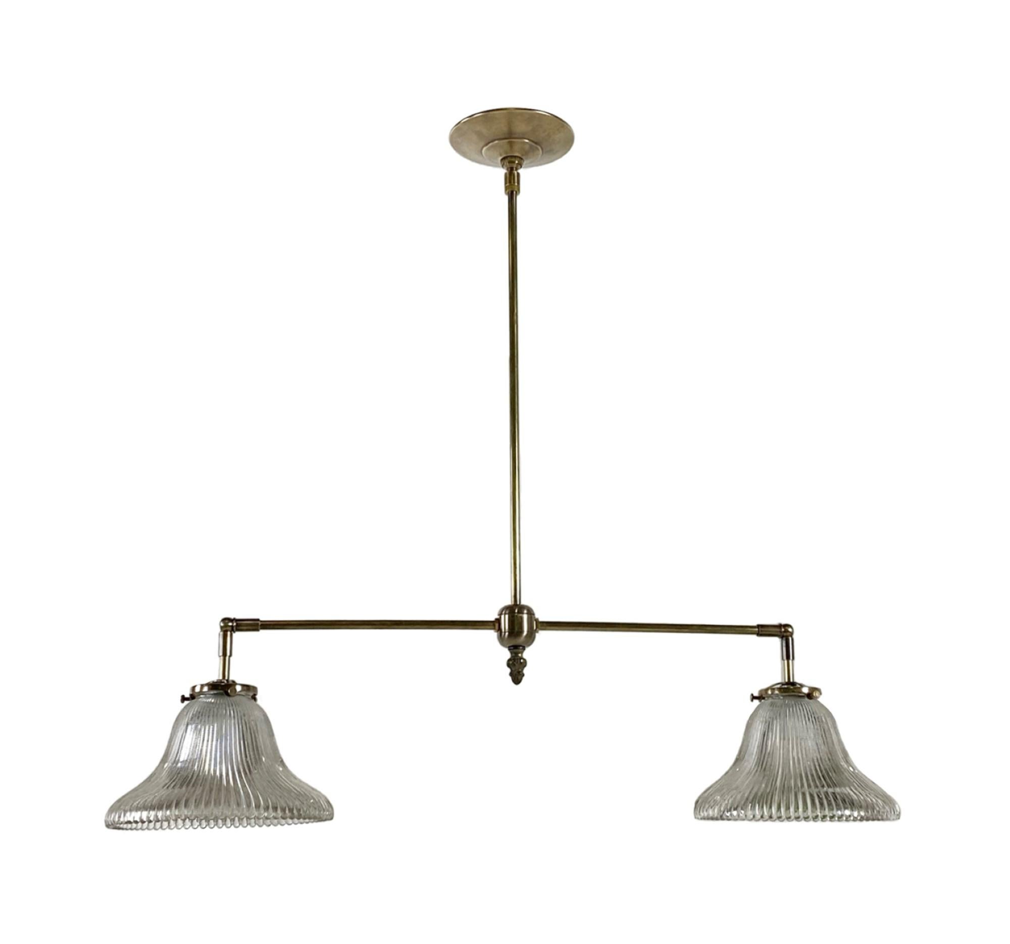 2010s Industrial style double pin striped prism glass pendant light with a new brass frame. Antique brass finish. This can be seen at our 400 Gilligan St location in Scranton, PA.