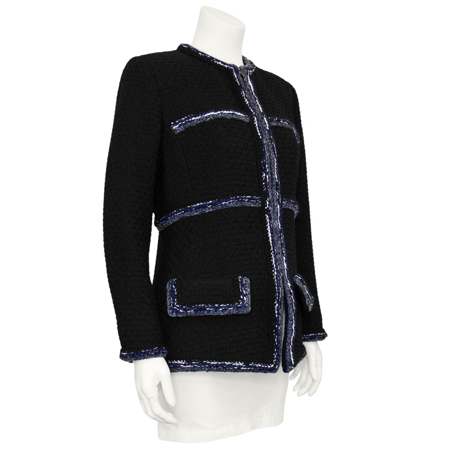 Amazing Chanel black boucle jacket from the 2010 era. The jacket features grey, navy and white boucle trim along the collarless neckline, front placket, pockets, cuffs and waist detail. The jacket zips up the front with a gunmetal tone zipper that