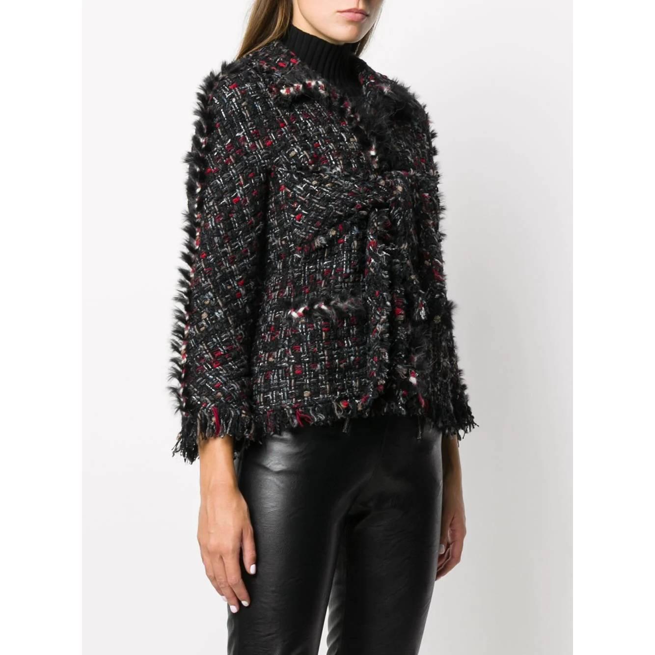 Chanel black wool blend jacket with intertwined white, red, gray and beige threads. Classic collar, front metal hook closure and knot fastening. Long sleeves, flap pockets, faux fur edges and frayed hems.

Years: 2010s

Made in France

Size: 42