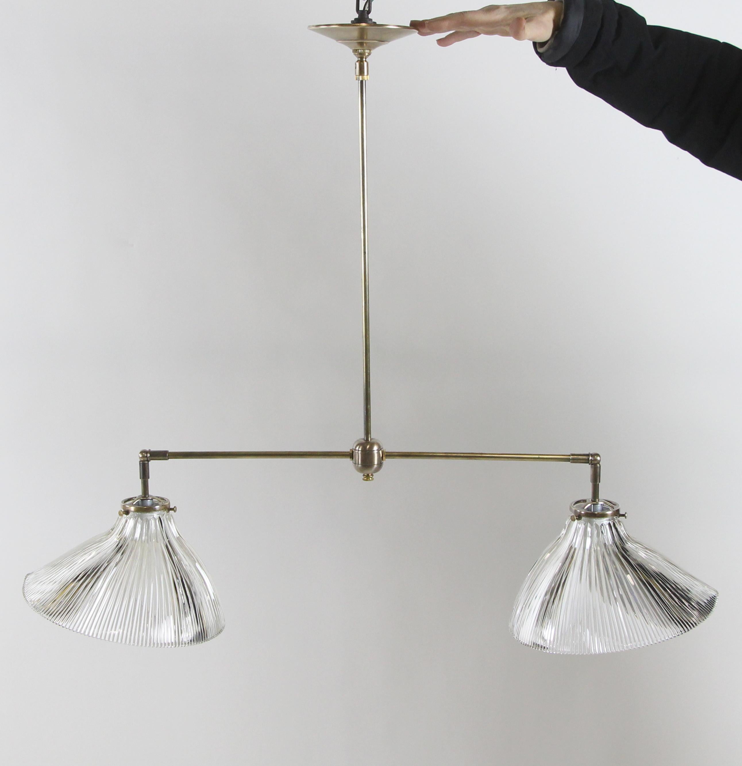 2010s new brass double pendant light fixture with antique clear prism glass Holophane shades. Antique brass finish. Cleaned and rewired. Small quantity available at time of posting. Priced each. Please inquire. Please note, this item is located in