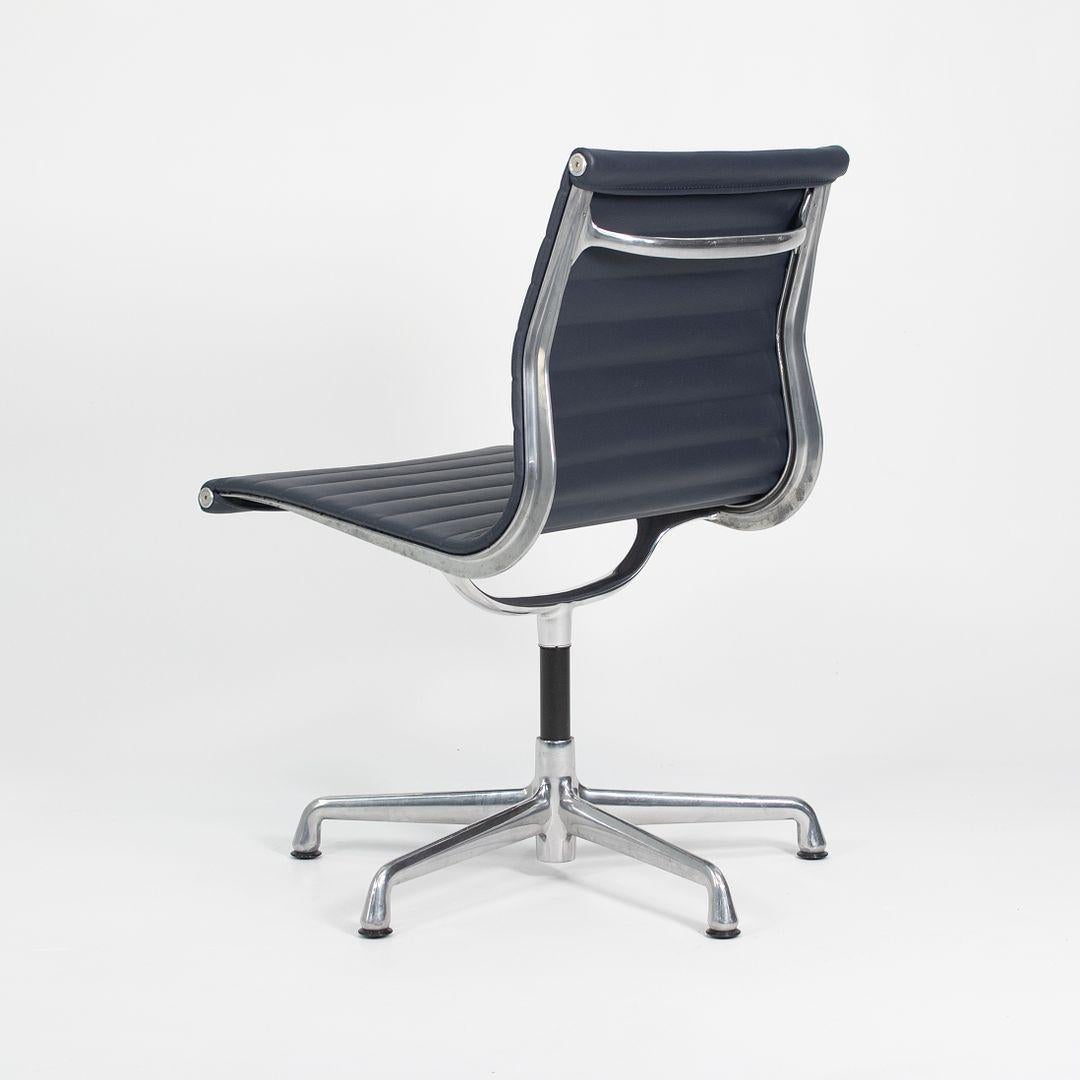 This is an Eames Aluminum Group armless desk or side chair, initially designed by Charles & Ray Eames for Herman Miller in 1958. This chair was produced in the 2010s. The design features a lightweight aluminum frame with a 5-star base, and has navy