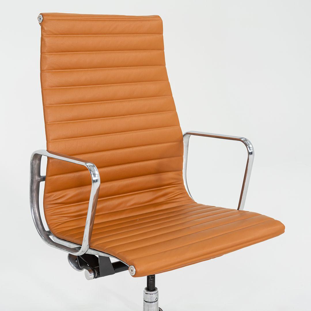 This is an Eames Aluminum Group Executive Desk Chair, initially designed by Charles and Ray Eames for Herman Miller in 1958. This particular example dates to the 2010s. The design features an adjustable aluminum 5-star base with a 360-degree swivel,