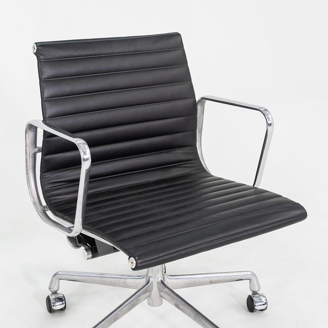 These are Eames Aluminum Group Management Desk Chairs, model EA335, originally designed by Charles and Ray Eames for Herman Miller in 1958. These particular examples date to the 2010s. Their design includes a solid yet lightweight aluminum frame and