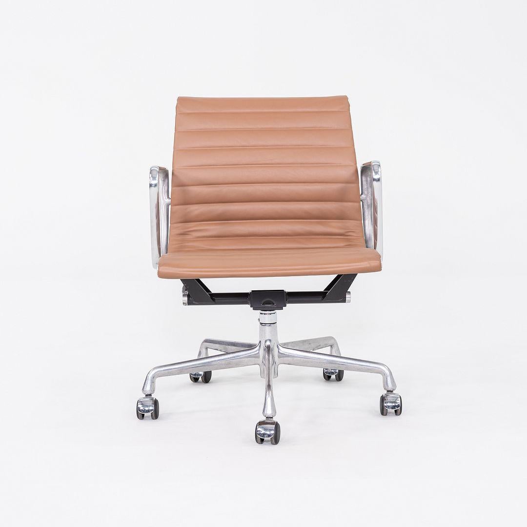 This is an Eames Aluminum Group Management Chair, Model EA335, originally designed by Charles and Ray Eames for Herman Miller in 1958. These particular examples were produced in the 2010s. Their design includes a solid yet lightweight aluminum
