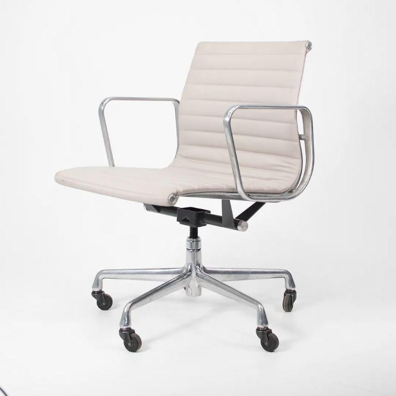 This is a single (multiple chairs are available, though the price listed is for each chair) Eames Aluminum Group Management Desk Chair in light gray leather, designed by Charles and Ray Eames for Herman Miller in 1958. This chair has a solid yet