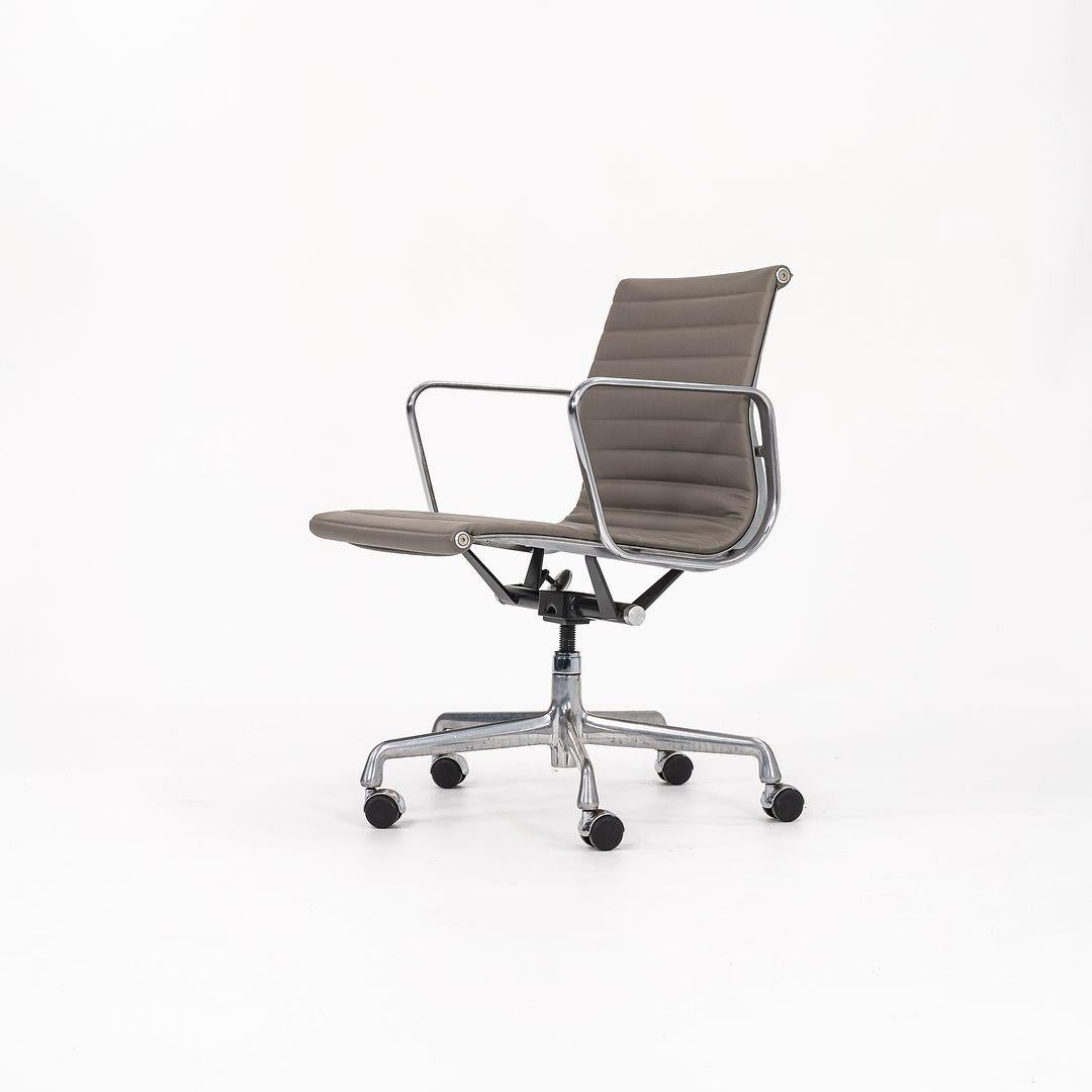 This is an Eames Aluminum Group Management Desk Chair, model EA335, originally designed by Charles and Ray Eames for Herman Miller in 1958. This example was produced in the 2010s. The design sports a solid yet lightweight aluminum frame and is