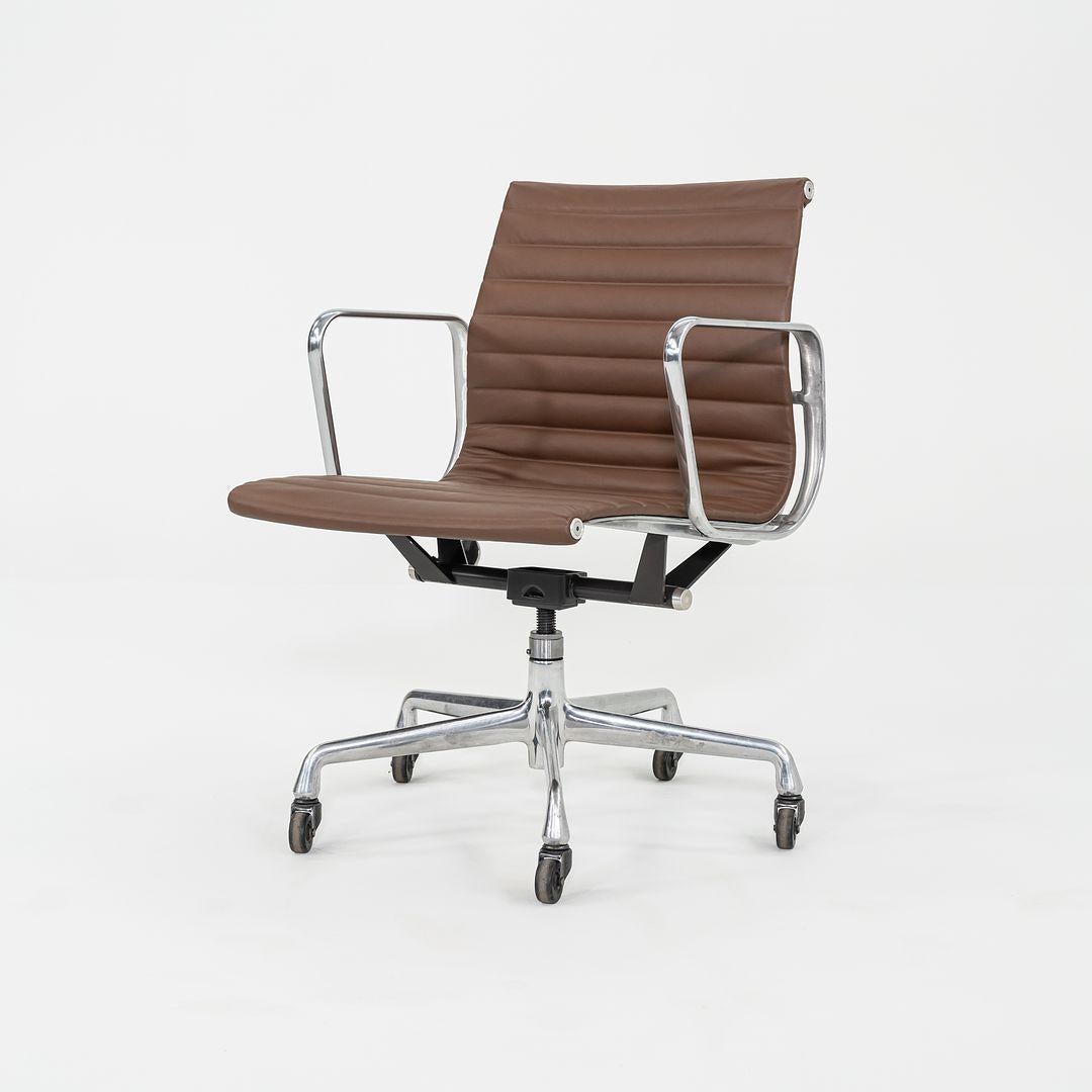 This is an Eames Aluminum Group Management Chair, originally designed by Charles and Ray Eames for Herman Miller in 1958. This particular example was produced in the 2010s. The design features an adjustable aluminum 5-star base with a 360-degree