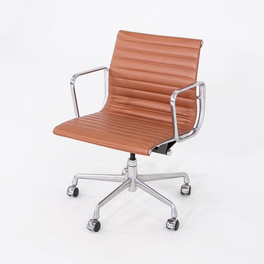 This is an Eames Aluminum Group Management Chair, Model EA335, originally designed by Charles and Ray Eames for Herman Miller in 1958. These particular examples were produced in the 2010s. Their design includes a solid yet lightweight aluminum