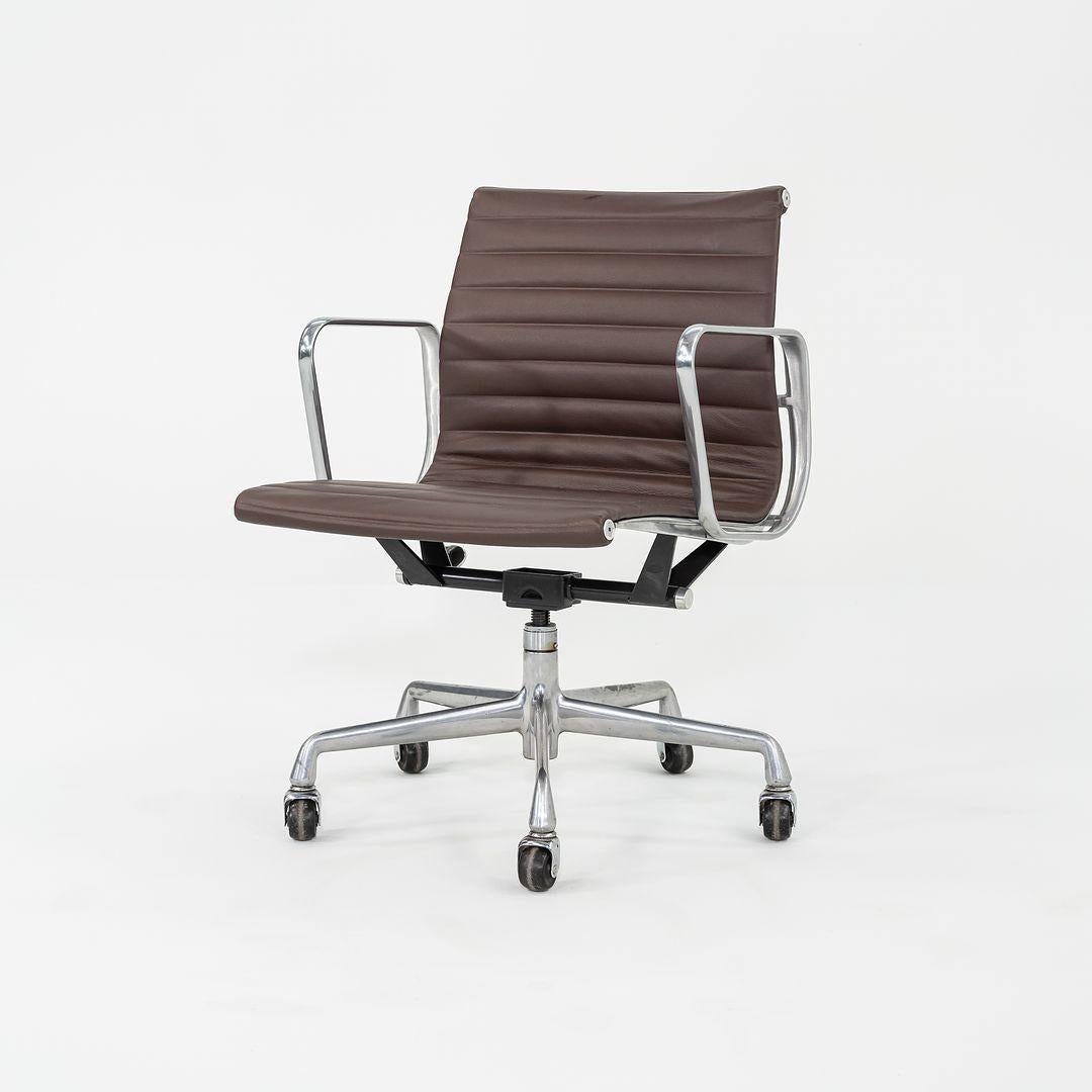 This is an Eames Aluminum Group Management Chair, originally designed by Charles and Ray Eames for Herman Miller in 1958. This particular example was produced in the 2010s. The design features an adjustable aluminum 5-star base with a 360-degree