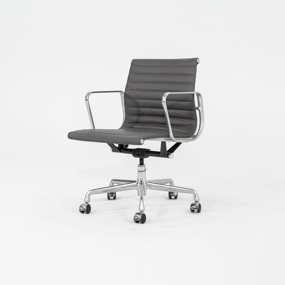 These are Eames Aluminum Group Management Chairs, originally designed by Charles and Ray Eames for Herman Miller in 1958. These particular examples were produced in the 2010s. Their design features an adjustable aluminum 5-star base with a