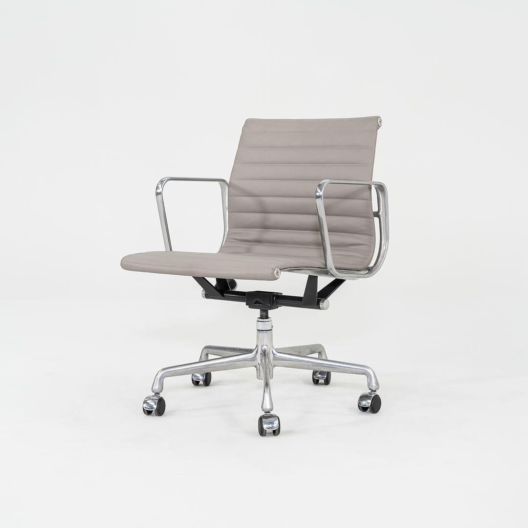 This is an Eames Aluminum Group Management Chair, originally designed by Charles and Ray Eames for Herman Miller in 1958. This particular example was produced in the 2010s. The design features an adjustable aluminum 5-star base with a 360-degree