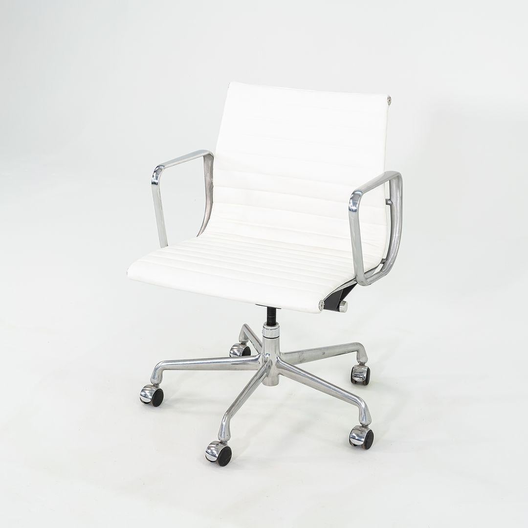 This is an Eames Aluminum Group Management Chair, originally designed by Charles and Ray Eames for Herman Miller in 1958. This particular example was produced in the 2010s. The design features an adjustable aluminum 5-star base with a 360-degree