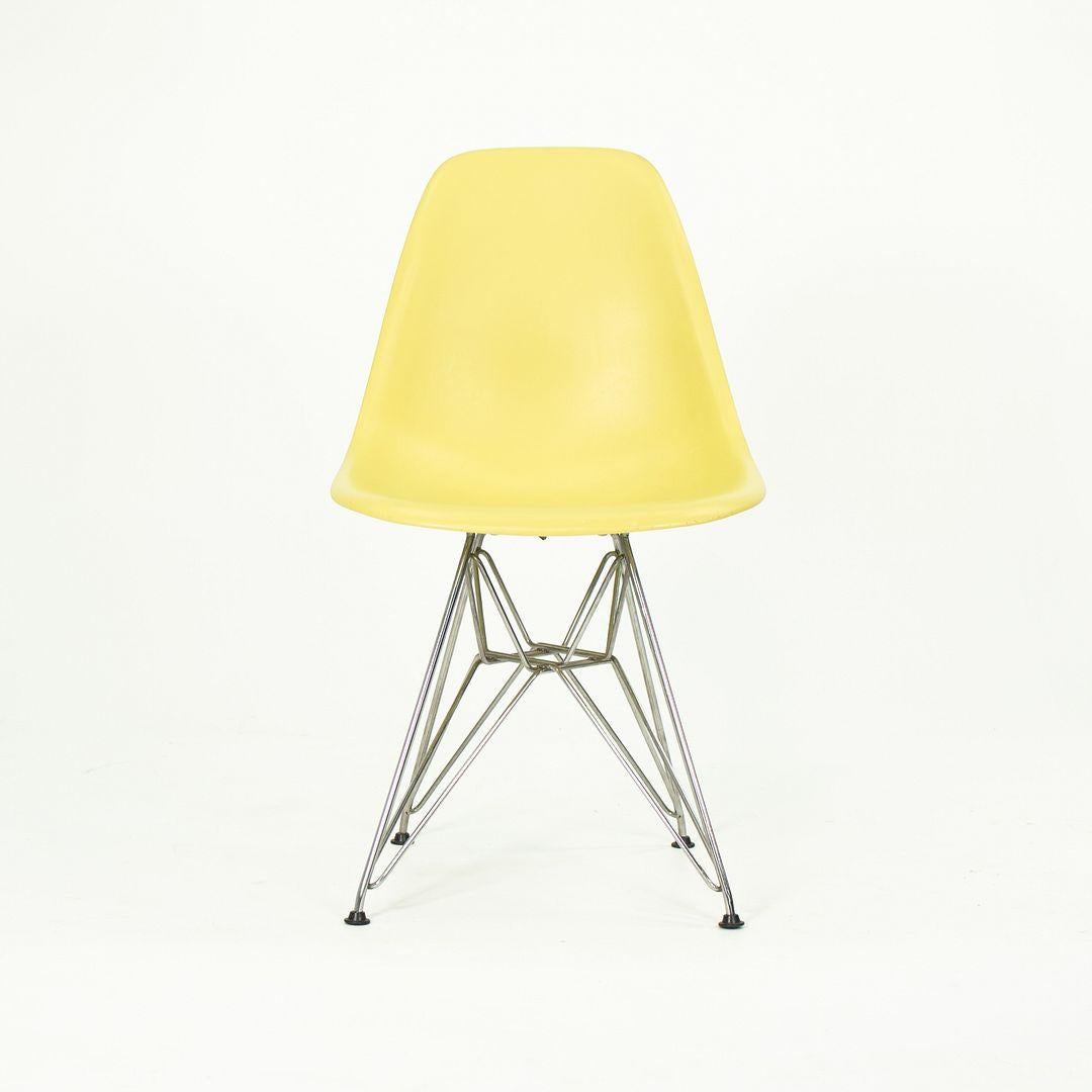 These are Eames DSR Chairs, originally designed by Ray and Charles Eames in the 1950s. These particular examples were produced by Herman Miller in the USA in the 2010s. These chairs feature plastic shells in yellow, and have Eiffel bases made of