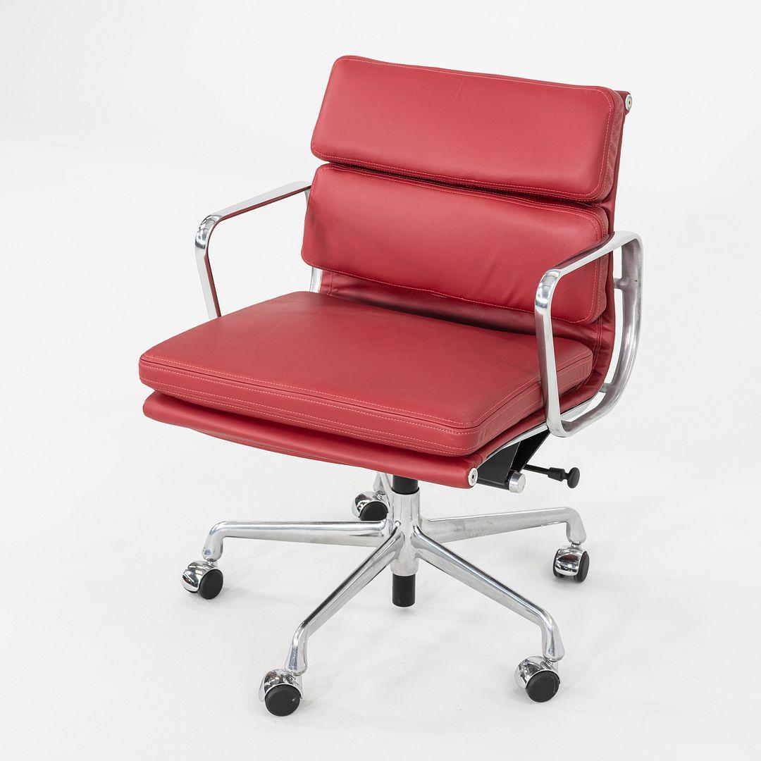 This is an Eames Aluminum Group Soft Pad Management Chair, Model EA435, originally designed by Ray and Charles Eames for Herman Miller in 1969. This example dates to the 2010s. The design features a cast aluminum frame and a pneumatic adjustable
