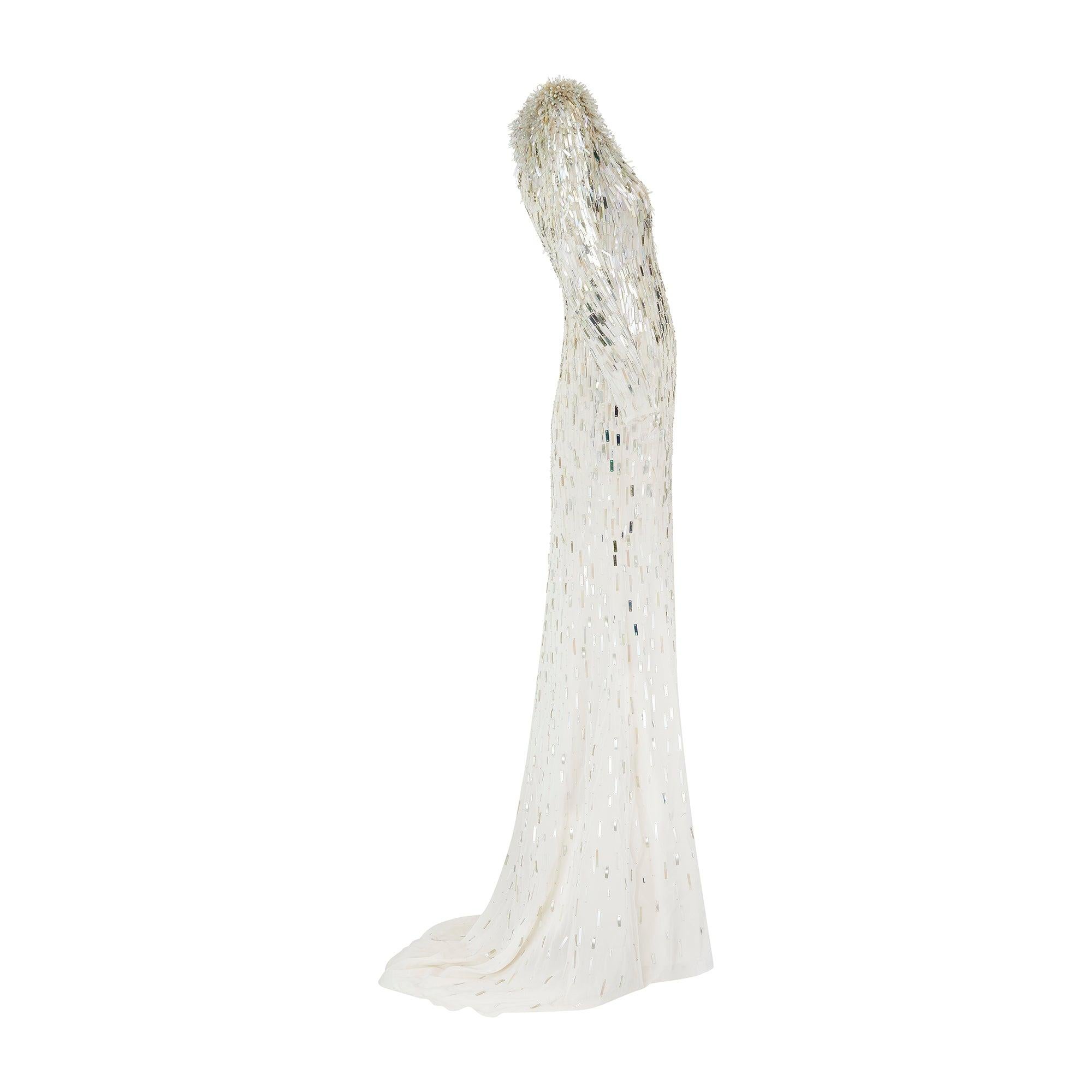 This high octane gown was designed by British designer and occasion-wear specialist Jenny Packham in the early 2010s and was probably part of a bridal or resort collection. Tailored from pale champagne silk with a semi-sheer finish, the silhouette