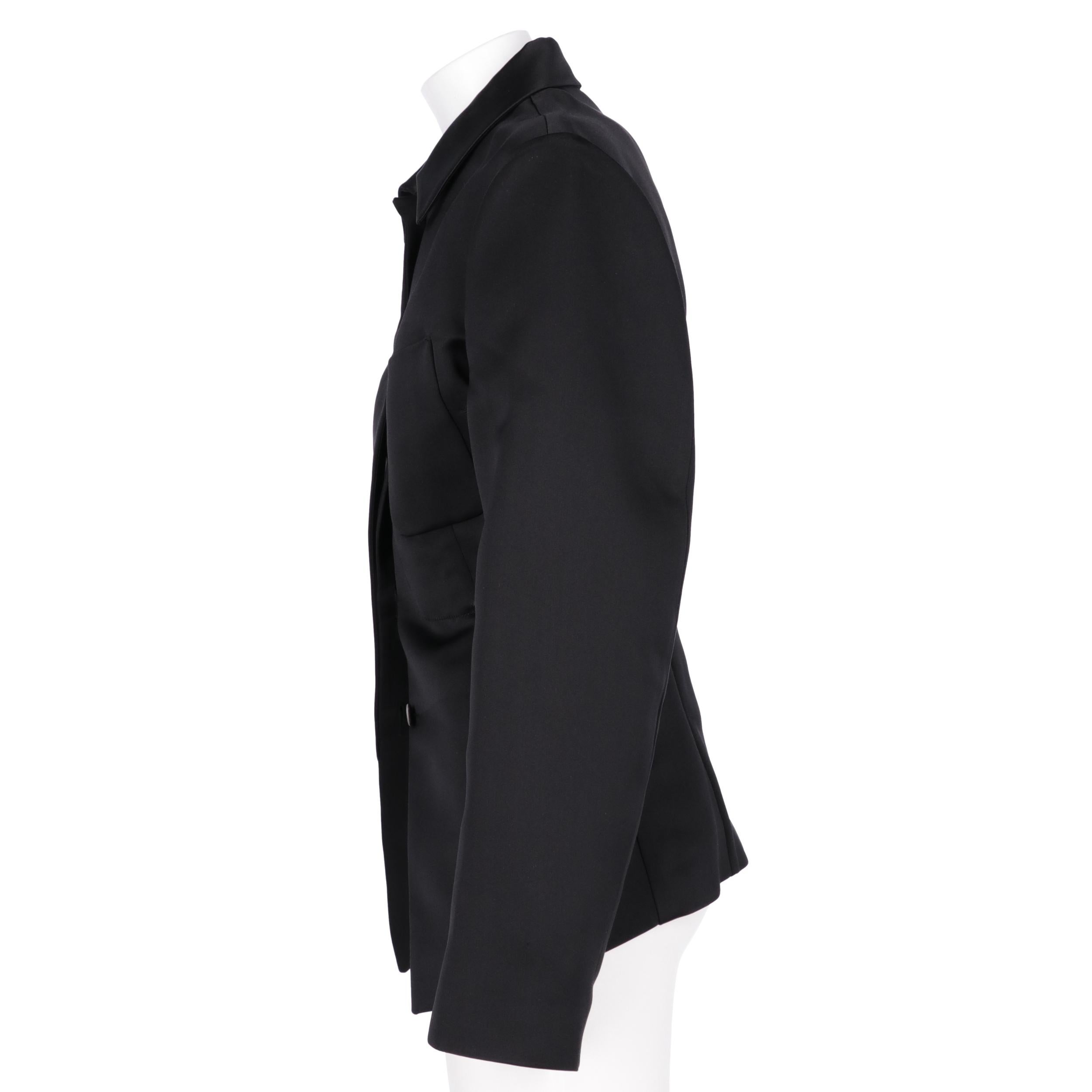 Jil Sander black slim-fit jacket. Classic collar, front English closure, long sleeves and patch pocket.
Years: 2014

Size: 34 EU

Flat measurements

Height: 72 cm
Bust: 48 cm
Shoulders: 38,5 cm
Sleeves: 64 cm
