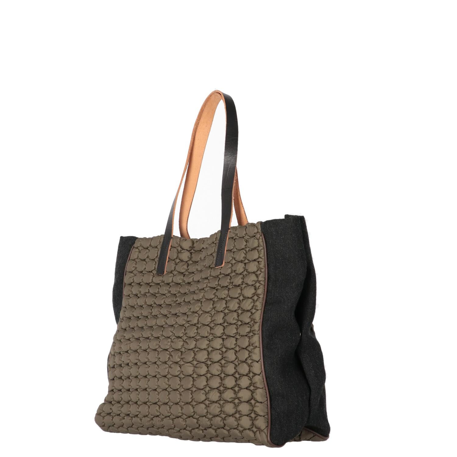A.N.G.E.L.O. Vintage - ITALY
Marni military green quilted nylon tote bag with dark gray wool blend fabric sides and snap buttons. Model with double leather handles, magnetic closure and internal pockets.
Years: Winter 2011

Made in Italy

Flat